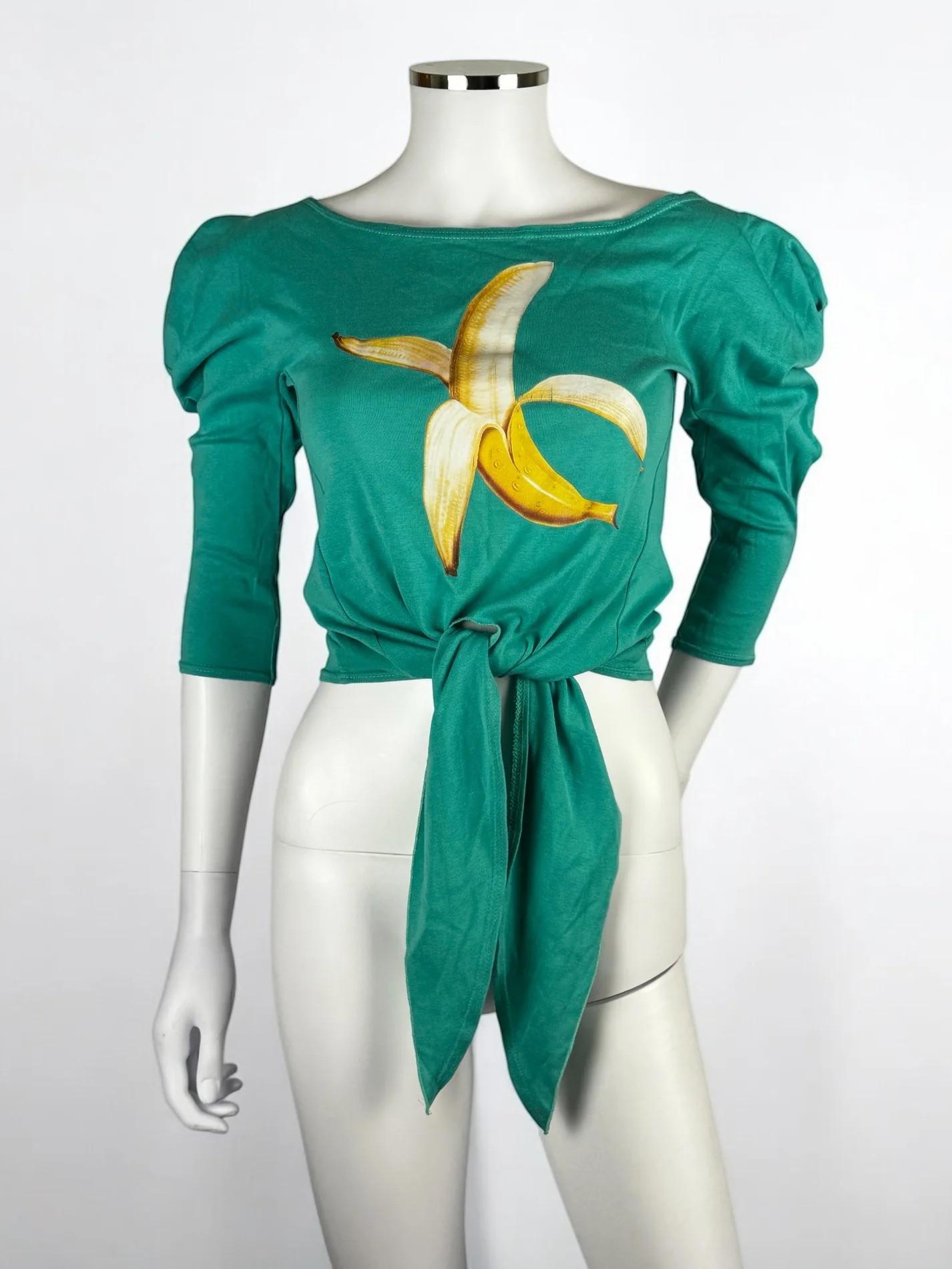 Chloé by Stella McCartney teal blue banana graphic tie front top, Spring Summer 2001
Can be worn on or off shoulders
Good vintage condition with some very minor cracking to graphic
Worn by Kylie Minogue in black in i-D magazine issue 208, 2001
100%