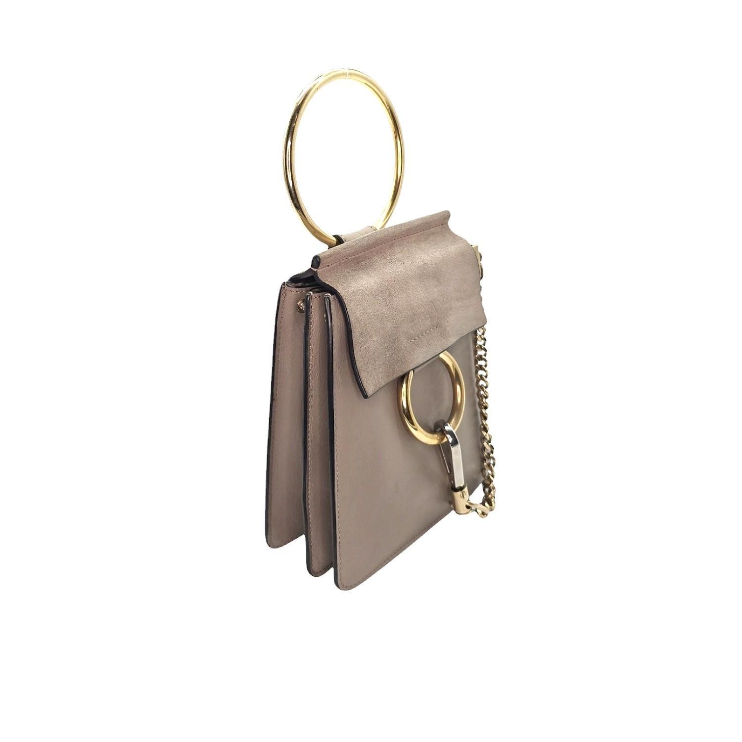 Enhance your style with the Chloe Calfskin Suede Mini Faye Bracelet Bag. Crafted from smooth calfskin and suede leather, this bag features gold hardware and a decorative ring attached to a clasp and chain. The flap opens to reveal a beige suede