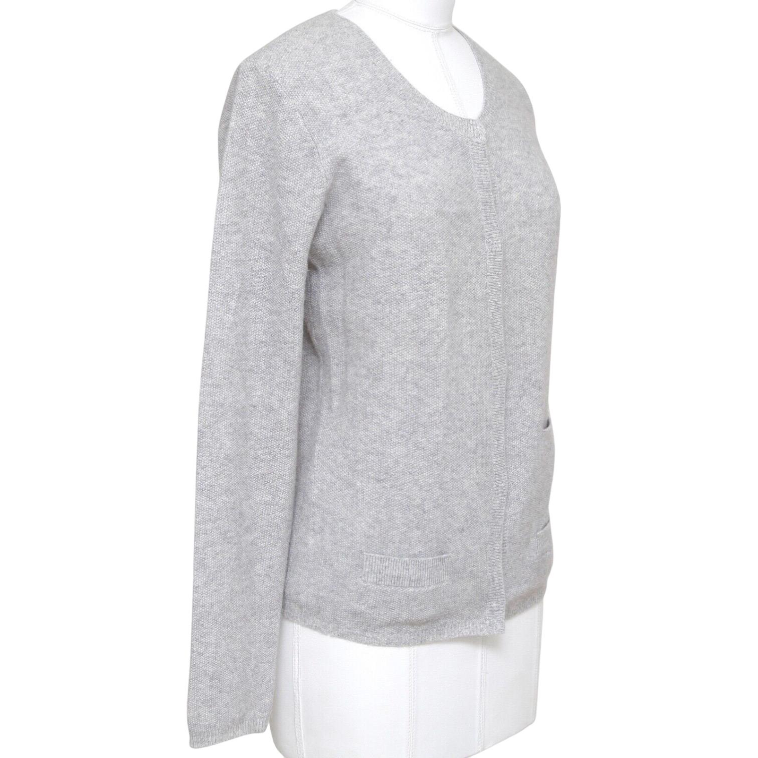 GUARANTEED AUTHENTIC CHLOE SOFT LIGHT GREY CASHMERE CARDIGAN

Details:
- Soft lightweight knit light grey cardigan has a great easy fit.
- Crew neck, front covered snap closure.
- Front slip pockets.
- Easy great piece for your Chloe