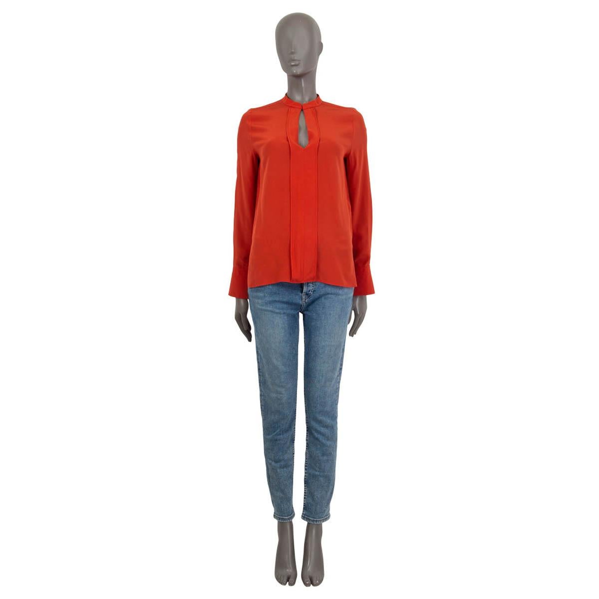 100% authentic Chloé long sleeve keyhole blouse in carmine red silk (100%). Features an oversized fit and buttoned cuffs. Opens with a concealed button at the neck. Unlined. Has a barely visible stain on the sleeve, otherwise in excellent