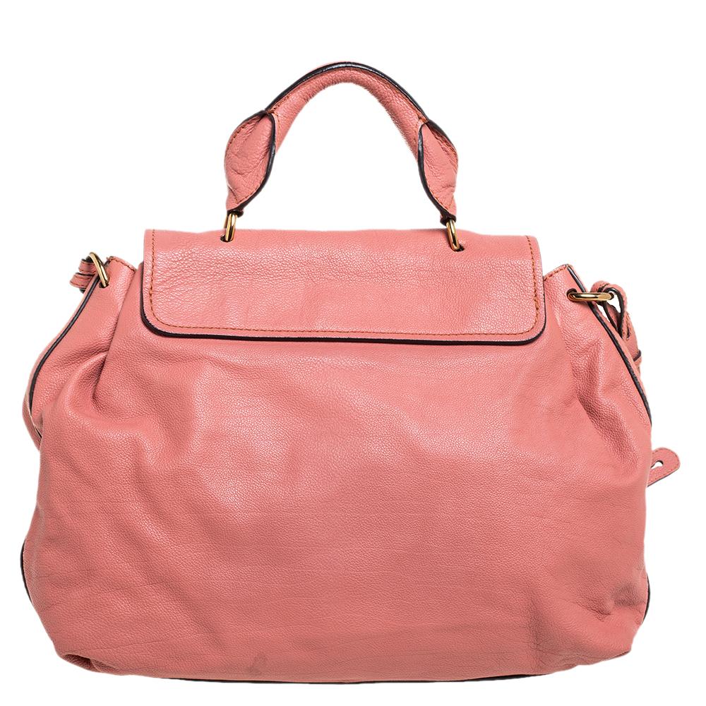 Every curve and detail on this Chloe Elsie is grand which adds to the worth of the bag. It has been crafted from leather and styled with a flap. The bag is secured by a turn-lock revealing a well-sized interior and completed with a top handle and a