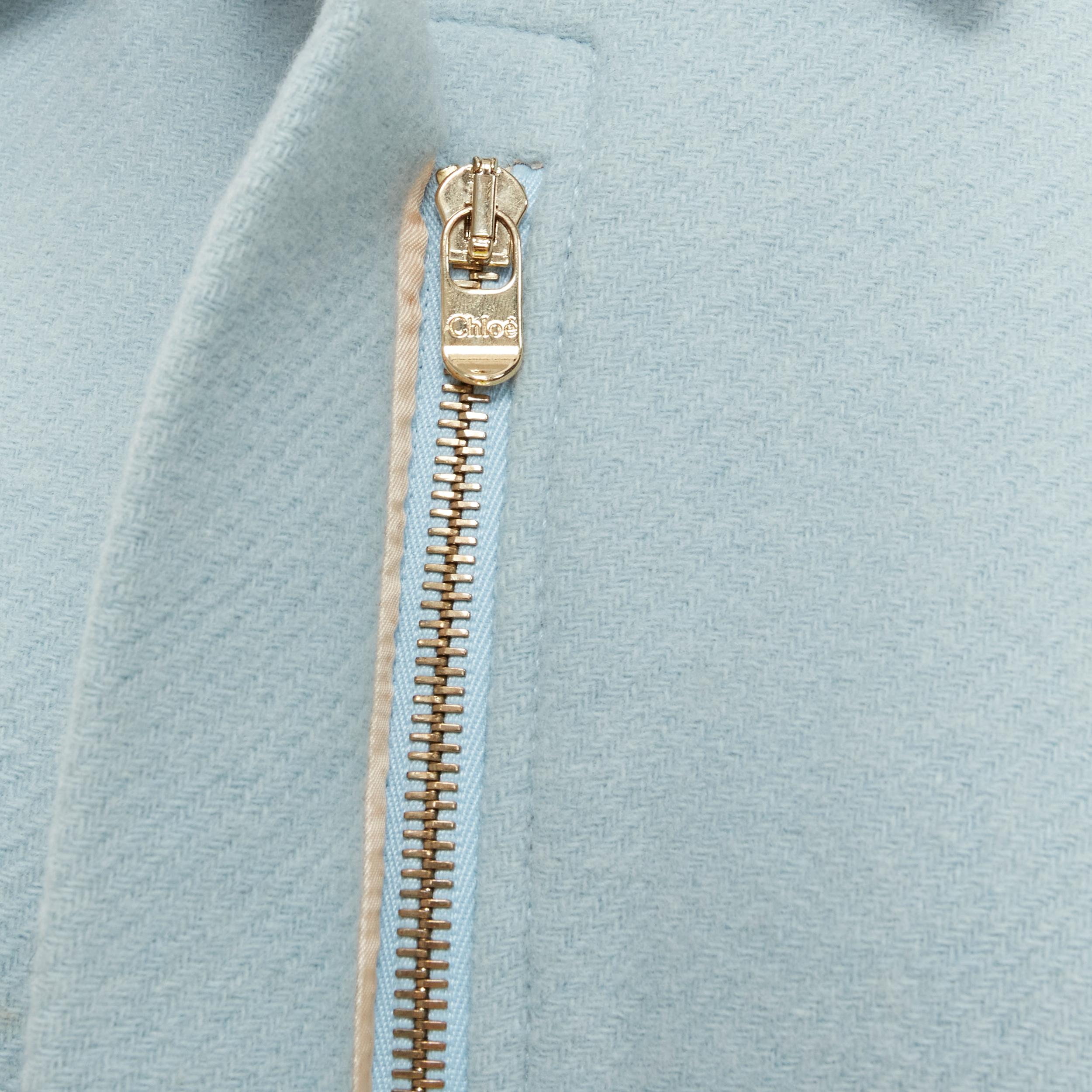CHLOE cloudy green blue virgin wool zip short poncho capelet jacket FR34 XS 
Reference: TGAS/B02045 
Brand: Chloe 
Material: Wool 
Color: Blue 
Pattern: Solid 
Closure: Zip 
Extra Detail: Light blue wool upper. Zip front and button at neckline.