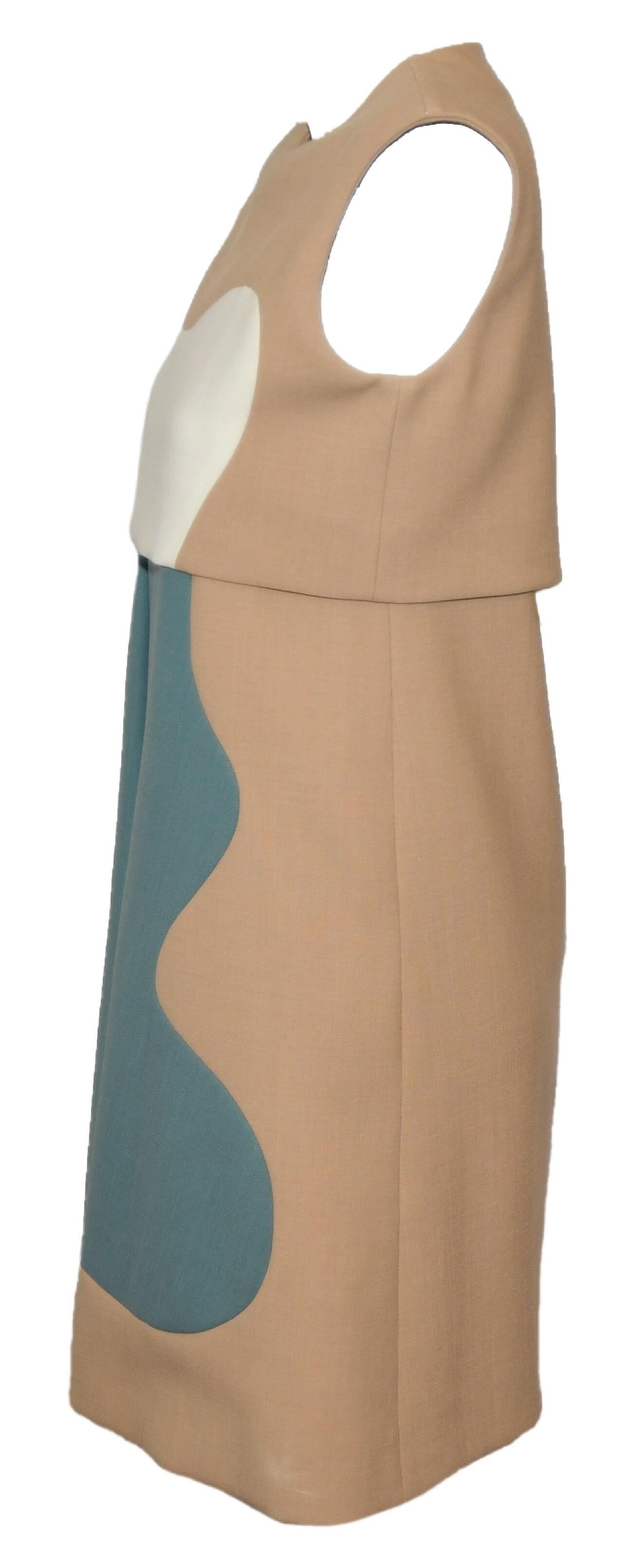 Chloe dress in the color block design includes distinctive structured color separations.  This round collar, sleeveless dress has a large pleat at front and wave like color blocking of the 3 different colors in white, sage and tan.  Dress is lined