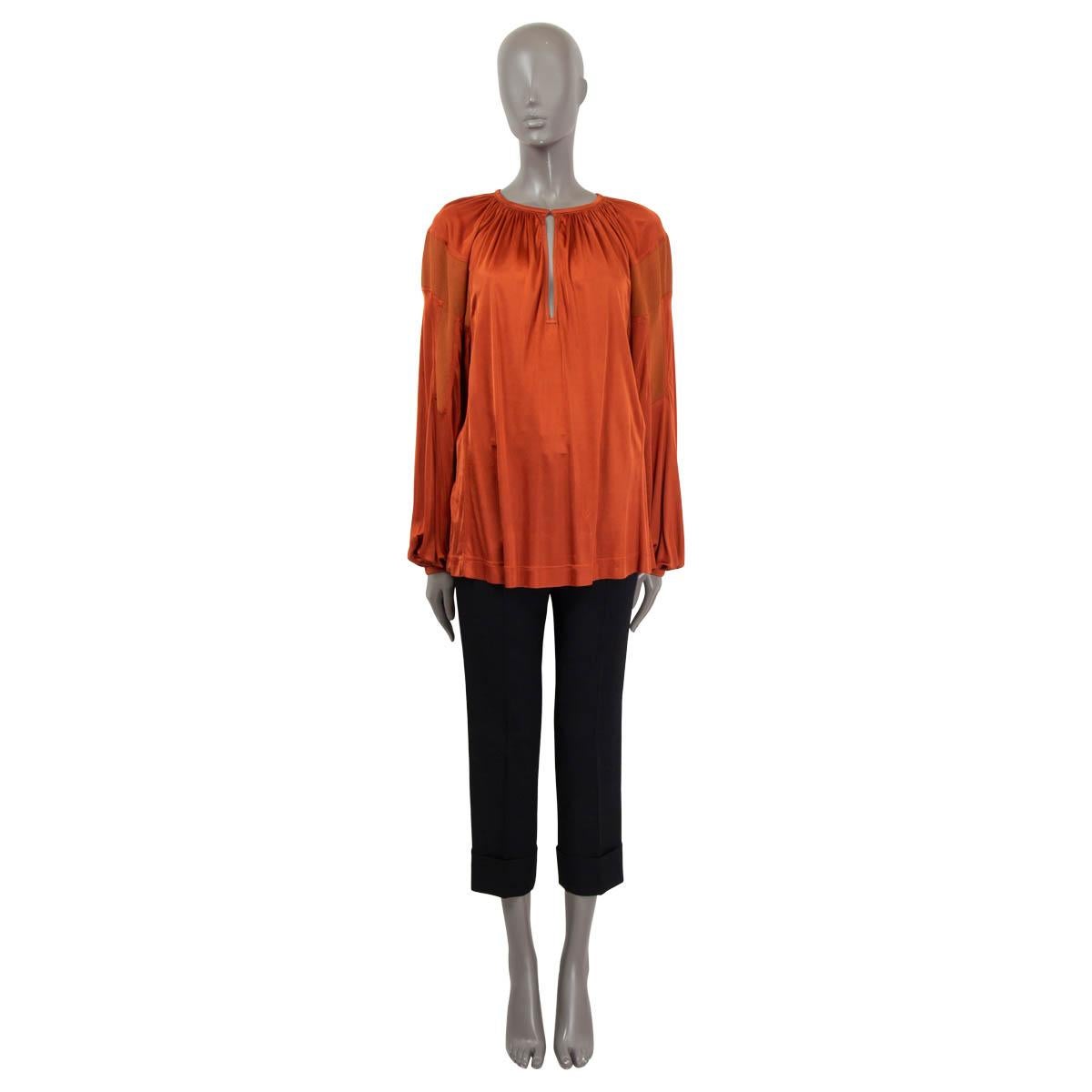100% authentic Chloé blouse in copper satin jersey viscose (100%) with crepe panels. Features balloon sleeves and a gathered heyhole-neck that closes with a concealed button. Unlined. Has been worn and shows tree small stains on the front. Overall