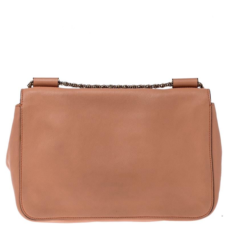 Every curve and detail on this Chloe Elsie is grand which adds to the worth of the bag. It has been crafted from leather and styled with a flap. The bag is secured by a turn-lock revealing a well-sized interior and completed with a chain shoulder