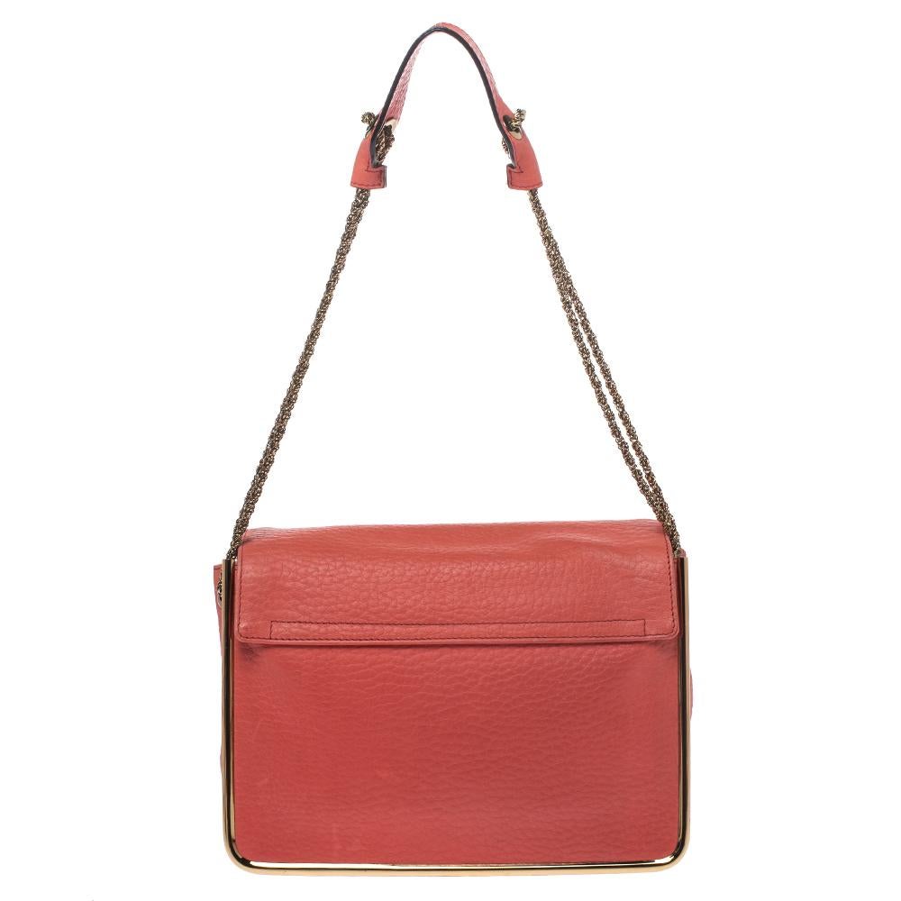 Gorgeous is the word for this Sally bag from Chloe! The coral orange bag has been crafted from leather and styled with a front flap that features a gold-tone flip-lock. It flaunts a chain and leather shoulder strap and comes equipped with protective