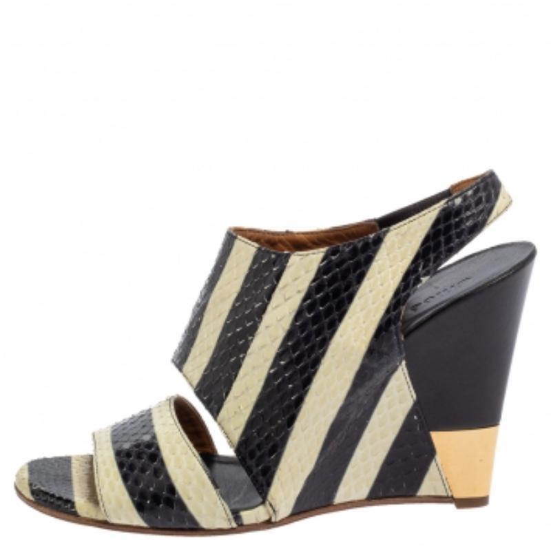 With a pair of wedges like these, you can undoubtedly stand out and win compliments! These cream and black sandals are crafted from python leather in an open-toe silhouette and styled with cut-out vamp straps and slingbacks. Endowed with comfortable