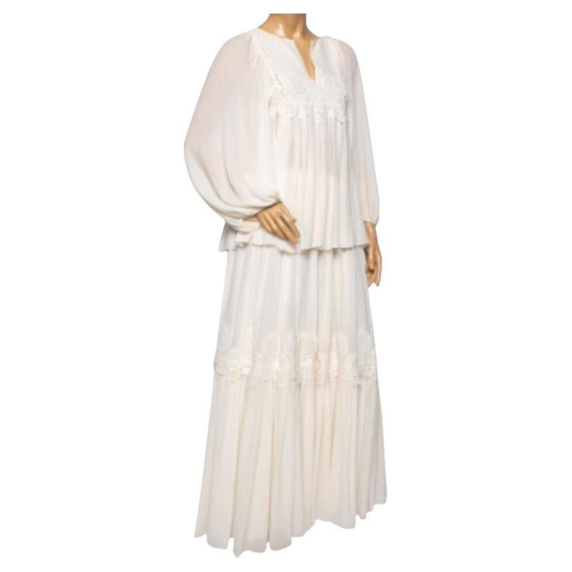 How pretty and elegant is this blouse and skirt set from Chloe! Crafted from silk, it has been stitched into a feminine, flowy silhouette and features lace trim details. Pair the cream-colored set with minimal accessories for a chic look.