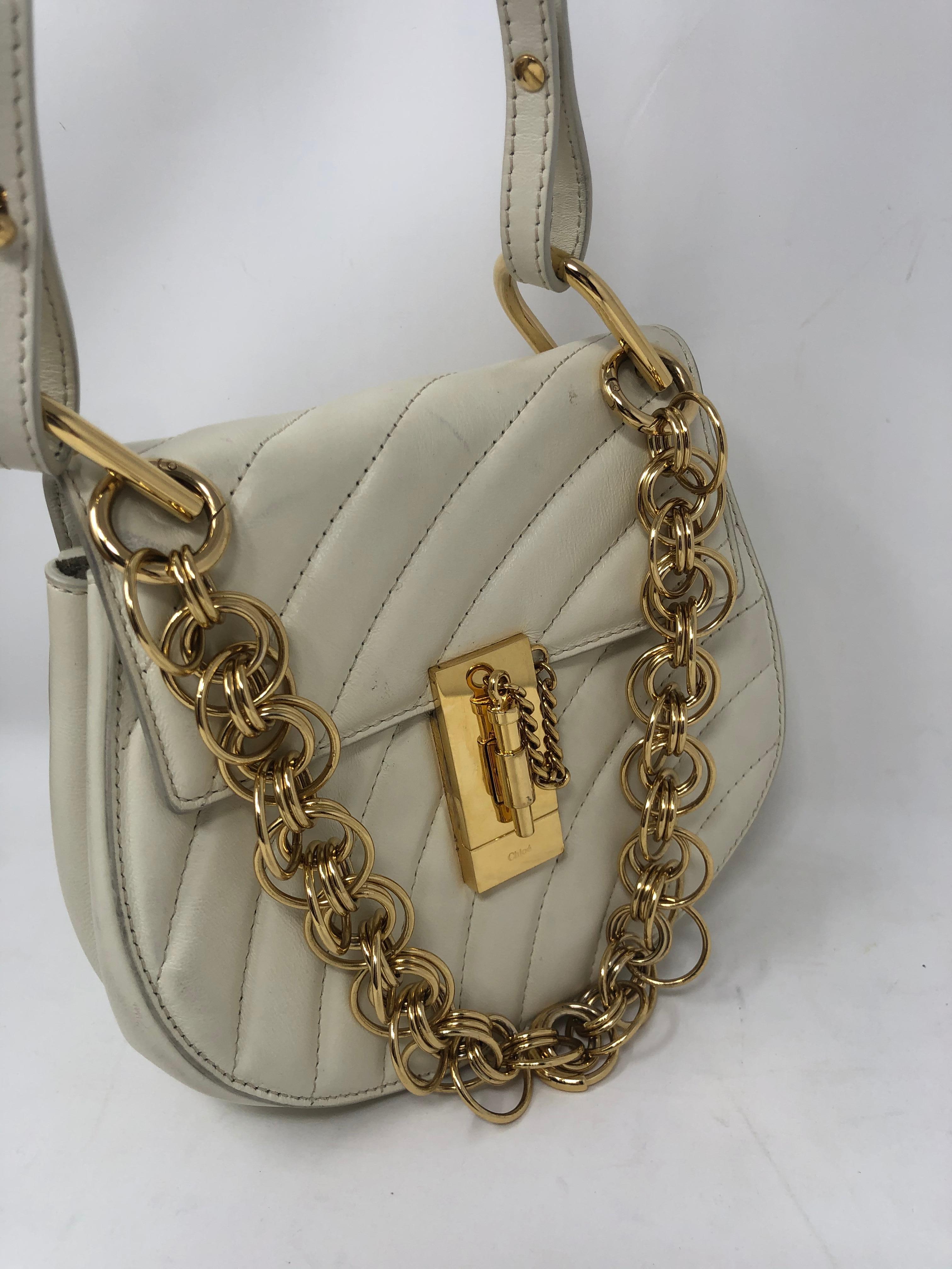 Chloe Cream Crossbody 2 Way Bag. Mini Drew style with extra gold chain in front. Cream leather bag with adjustable strap. Pretty gold hardware. Some minimal wear by hardware. Nice style and look from Chloe. Guaranteed authentic. 