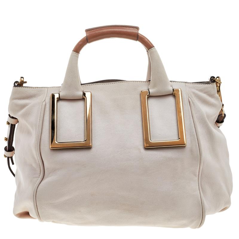 A stunning handbag from Chloé for everyday use! This Chloé Ethel satchel is crafted from leather that comes in a lovely cream hue. It features top leather handles, a zip closure, and gold-tone hardware. It comes with a canvas-lined interior spaced