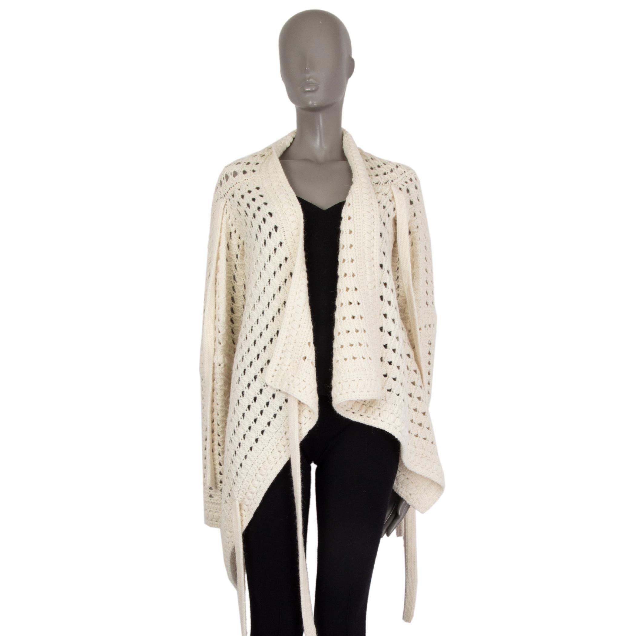 authentic Chloé asymmetric wrap-knit in cream acrylic (46%) alpaca (35%) wool (19%) with strings for multi-tie purpose, crochet knit, mid-heavy weight. Unlined. Has been worn and is in excellent condition.

Measurements
Tag