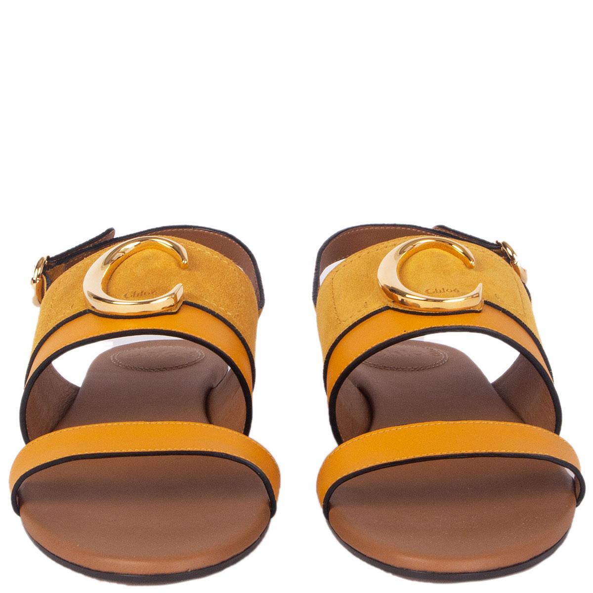 100% authentic Chloé C logo flat sandals in curry yellow suede and leather featuring gold-tone metal embellishment. Closes with a buckle on the side. Brand new. Come with dust bag. 

Imprinted Size	37.5
Shoe Size	37.5
Inside Sole	24cm