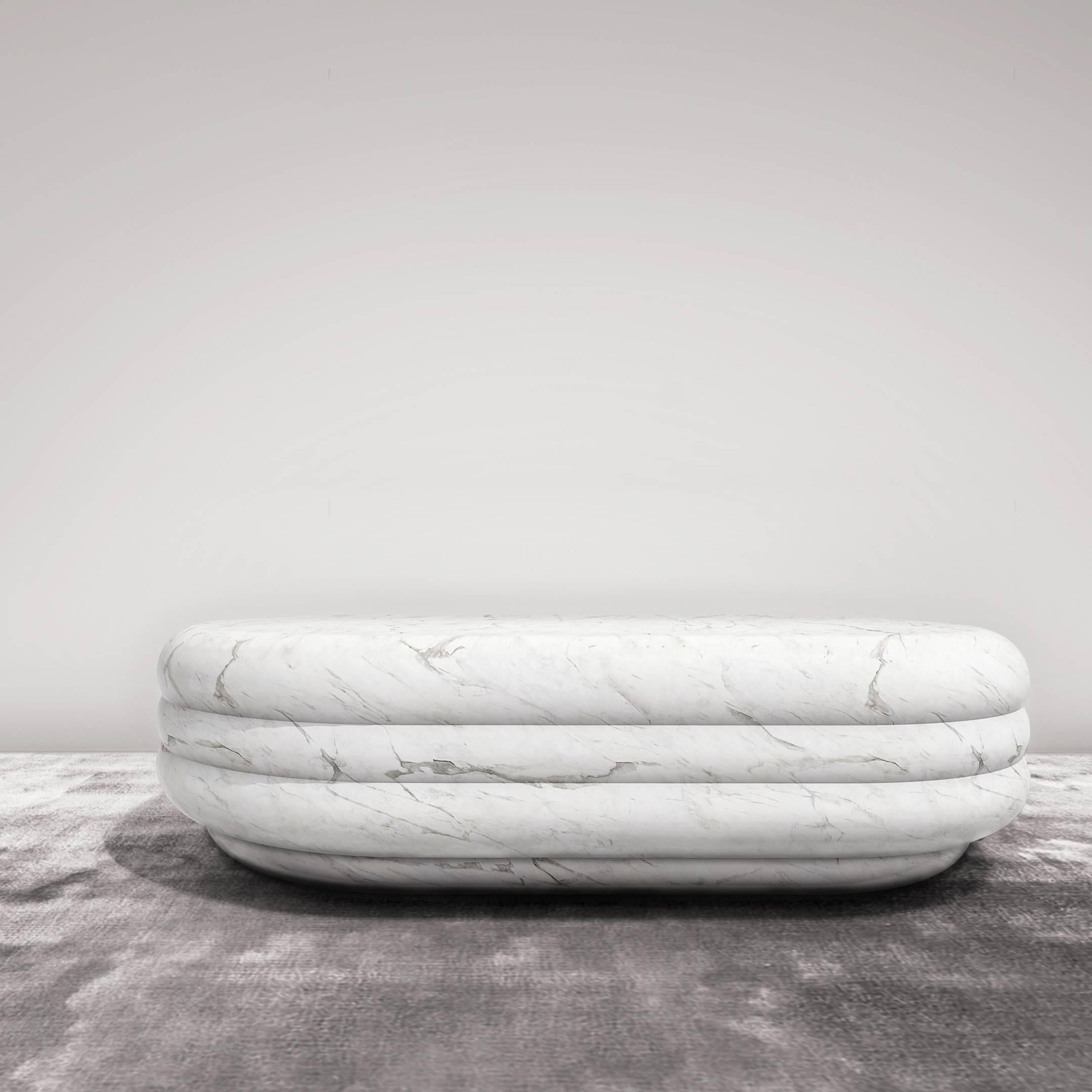 In ancient Rome and Greece figures of divinities were sculpted in marble and so is this modern-day coffee table inspired by bodily curves. Carved from a solid block of marble, the voluptuous silhouette and silky honed surface of the oval shape