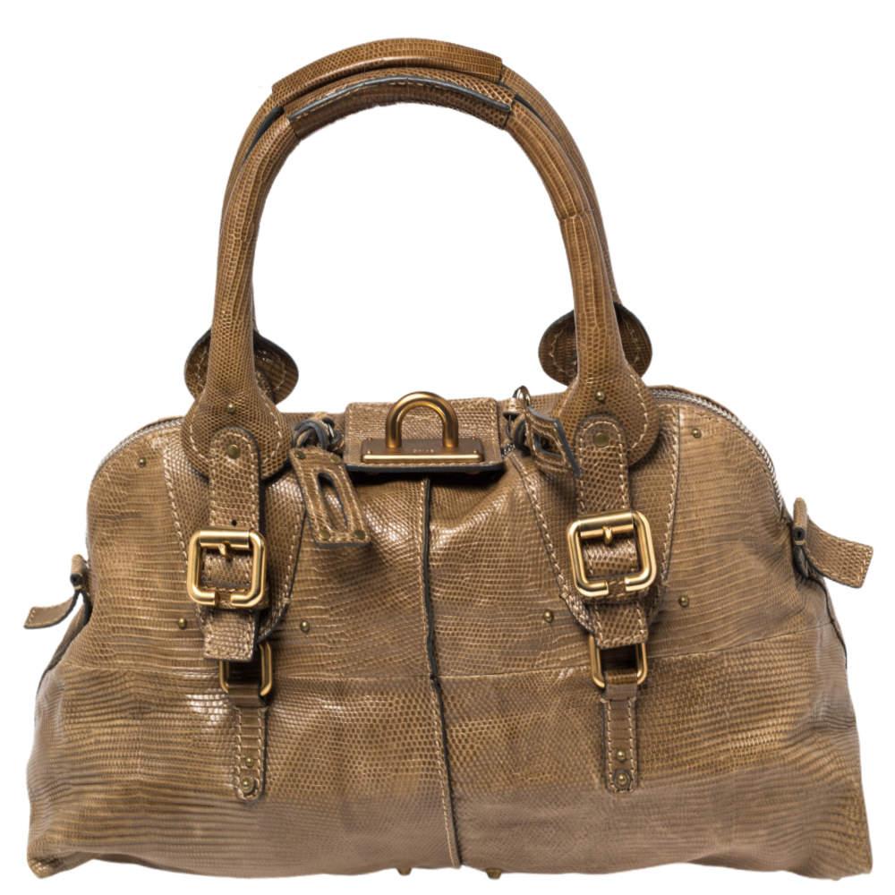 This Chloé Paddington Dome satchel is built to assist your impeccable style on all days. Gold-tone hardware with a chunky lock acts as the highlight of this iconic creation. The exterior is in dark beige lizard leather while the interior is in
