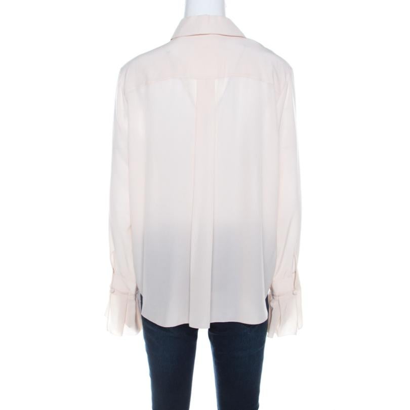 Masterfully crafted from the house of Chloe, this blouse comes in a dusty shade of pink. Tailored from smooth silk, it features a classic collar and long sleeves with ruffled detailing on the cuffs as well as the front. The creation is guaranteed to