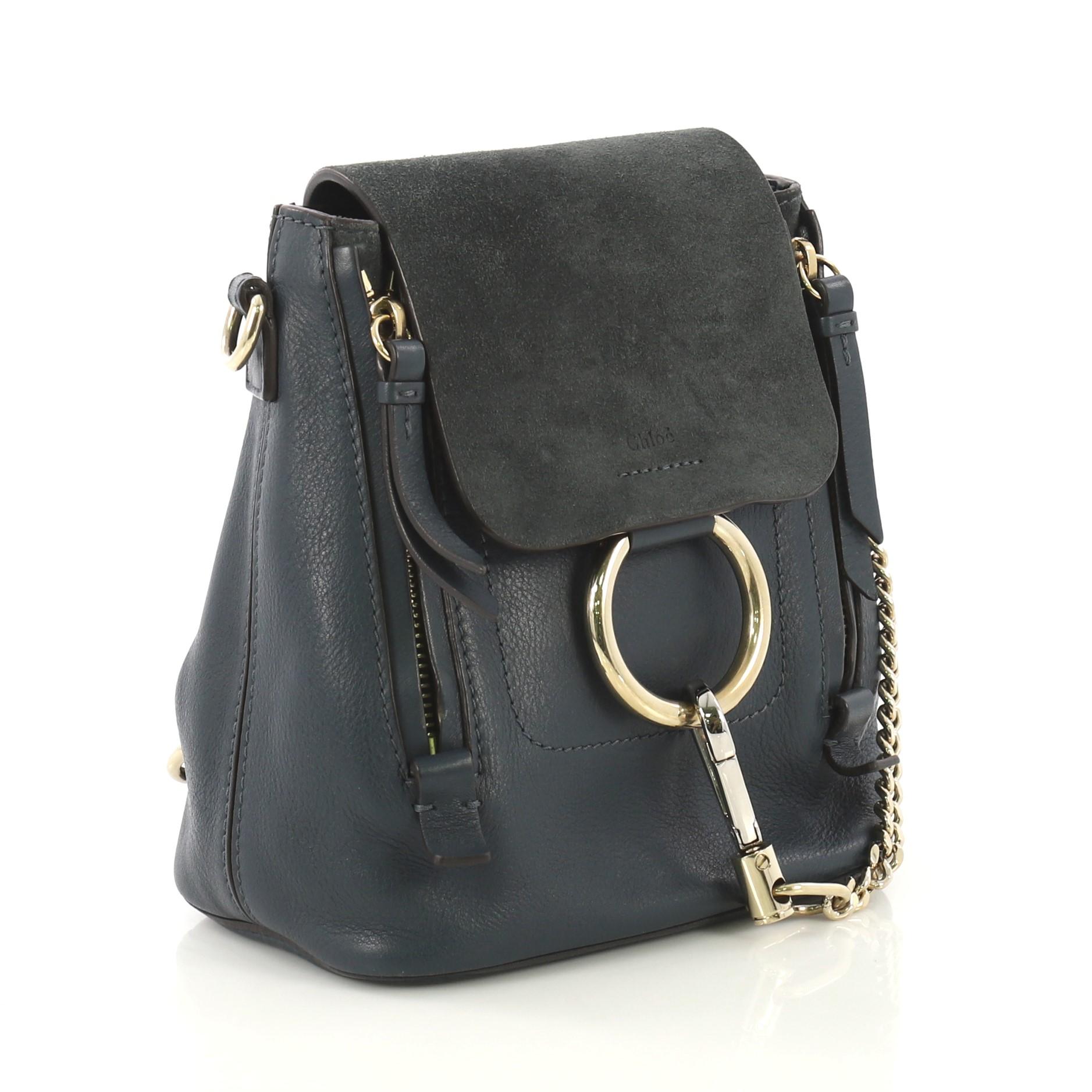 This Chloe Faye Backpack Leather and Suede Mini, crafted from teal leather and suede, features a detachable flat top handle and shoulder strap, flap with chain-clip and ring detail, expandable zip sides, and gold-tone hardware. Its flap opens to a