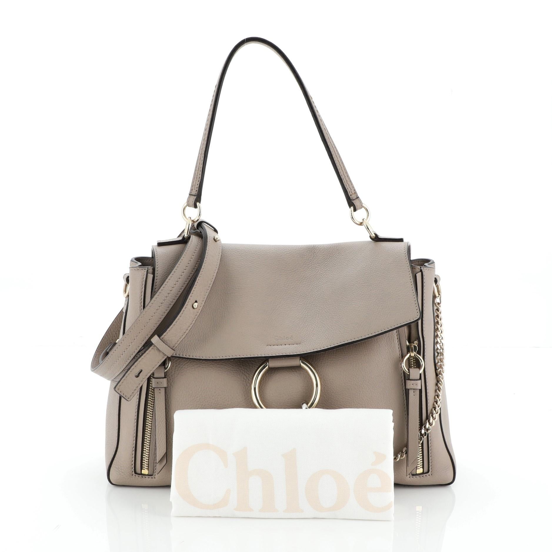 This Chloe Faye Day Bag Leather Medium, crafted from neutral leather, features leather top handle, removable shoulder strap, flap top with chain-clip and ring detail, dual side zips that expand bag, and silver-tone hardware. It opens to a neutral