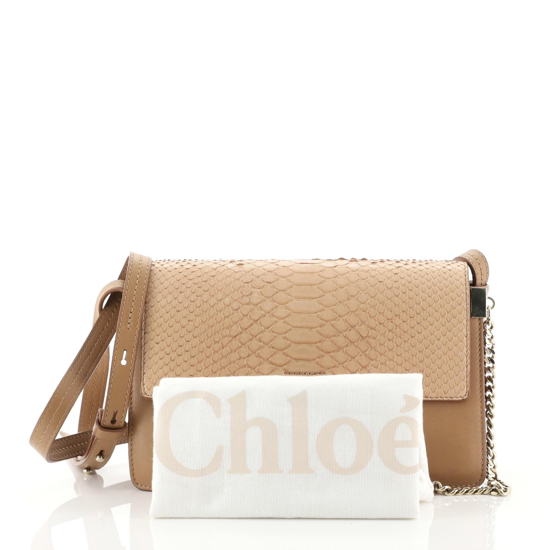This Chloe Faye Shoulder Bag Leather and Python Small, crafted with neutral leather and genuine python, features an adjustable shoulder strap, ring with chain lock closure, and gold-tone hardware. Its hidden magnetic snap closure opens to a neutral