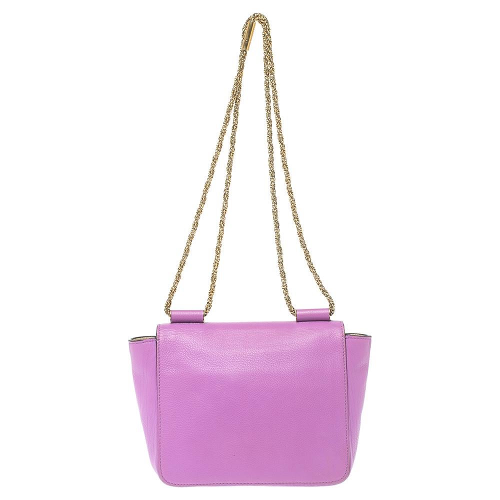 Every curve and detail on this Chloe Elsie is stylish, which adds to the bag's worth. It has been crafted from quality leather and styled with a flap. The fuchsia-hued bag is secured by a turn-lock revealing a well-sized leather-lined interior and