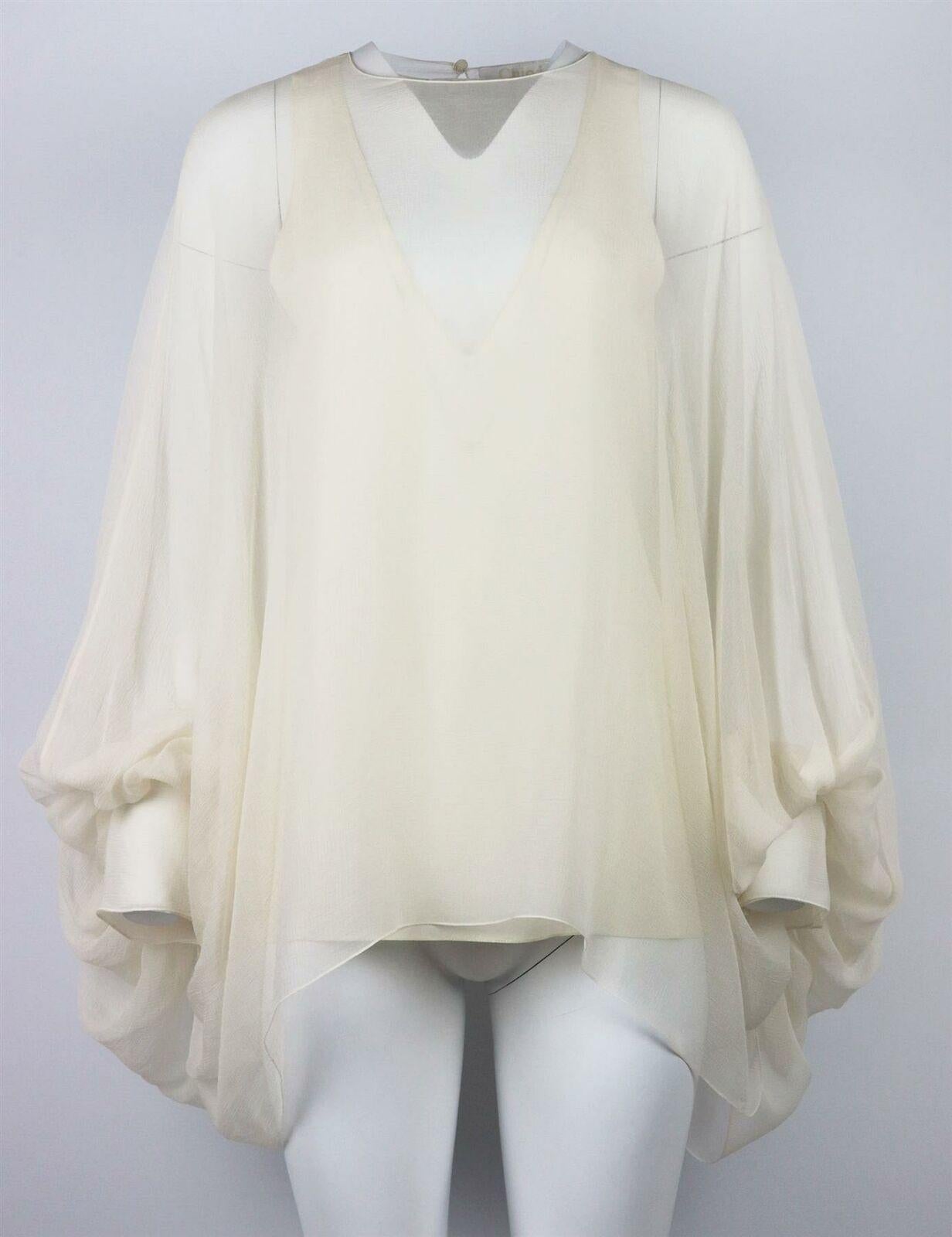 This lightweight blouse by Chloe is imbued with the label's ethereal romance, the diaphanous silhouette is crafted from ivory-hued silk-georgette, with long balloon sleeves that are delicately gathered by oversized cuffs and ribbon tie. Ivory