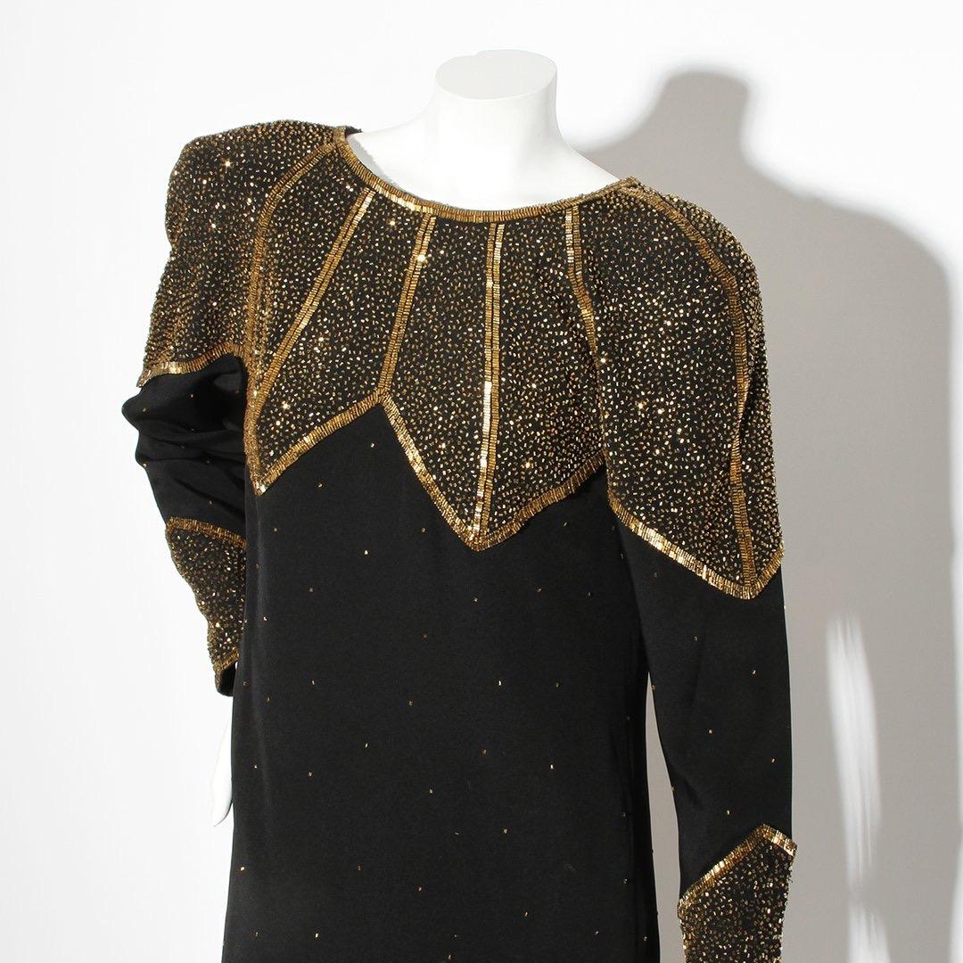 Product Details:
Gold beaded long sleeve dress by Karl Lagerfeld for Chloe 
Circa 1990-1999
Black polyester evening gown
Gold beading embroidery throughout 
Rounded neck 
Button cuff closure 
Keyhole back 
Shoulder pads 
Invisible back zipper with