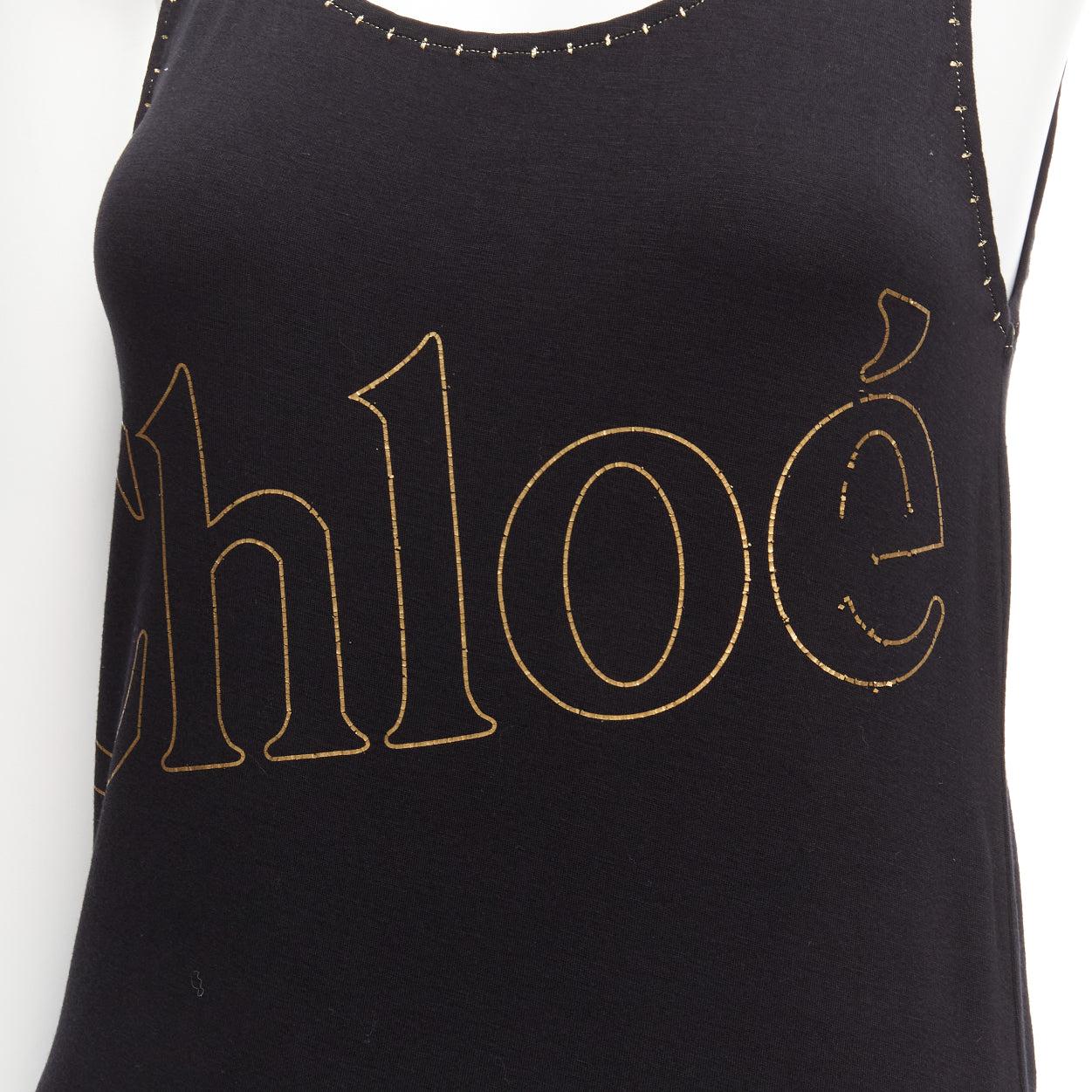 CHLOE gold foil logo black topstitch detail rock chic tank top dress S
Reference: SNKO/A00286
Brand: Chloe
Material: Rayon, Blend
Color: Black, Gold
Pattern: Solid
Closure: Pullover
Made in: Italy

CONDITION:
Condition: Fair, this item was pre-owned