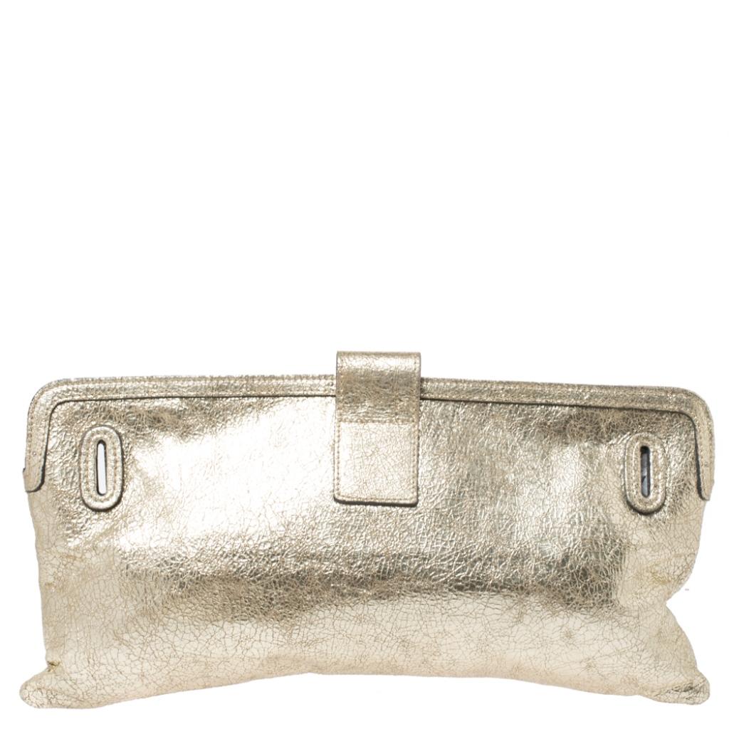 Masterfully crafted, this Chloe clutch has an appealing metallic gold leather exterior with a tuck-in flap closure at the front. A functional interior with a zipped pocket elevates the charm of this clutch.

Includes: Original Dustbag

