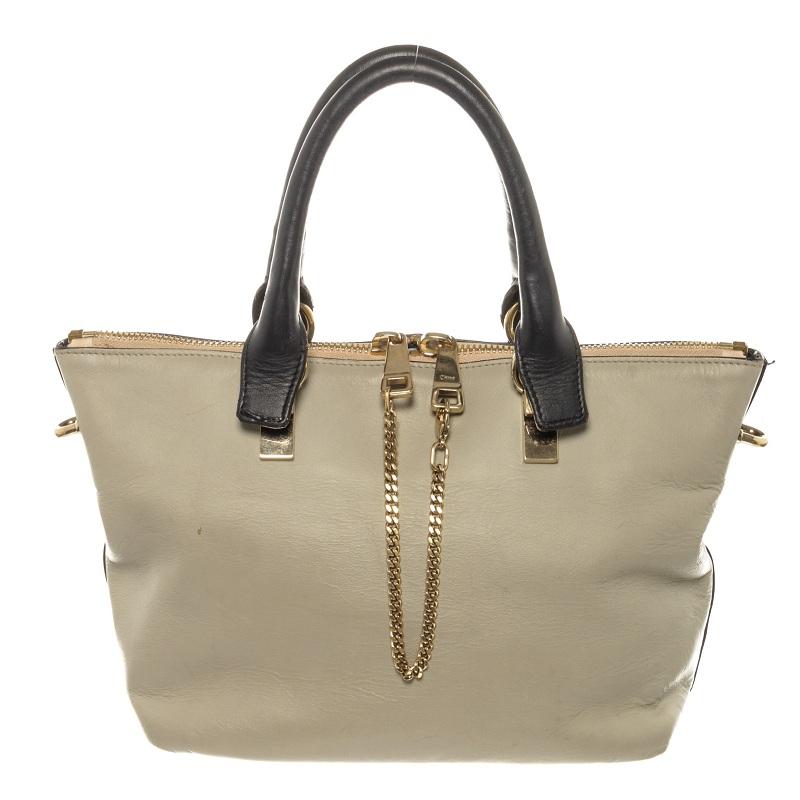Baylee Medium Two-tone tote from Chloé is crafted from Calfskin leather in black and gray. The bag features an adjustable shoulder strap, two gold-tone zipper fastening along the top. The interior of the bag consist of brown canvas lining with slip