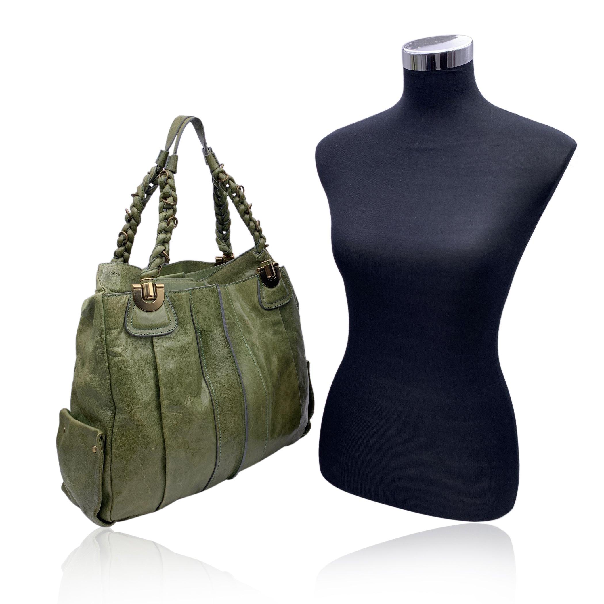 Gorgeous CHLOE 'Heloise Bag ' crafted in genuine leather in green color. Braided handles. Gold metal hardware. Magnetic button closure. The interior is done in a beige canvas textile and includes a side zipper pocket and 1 open pocket inside.