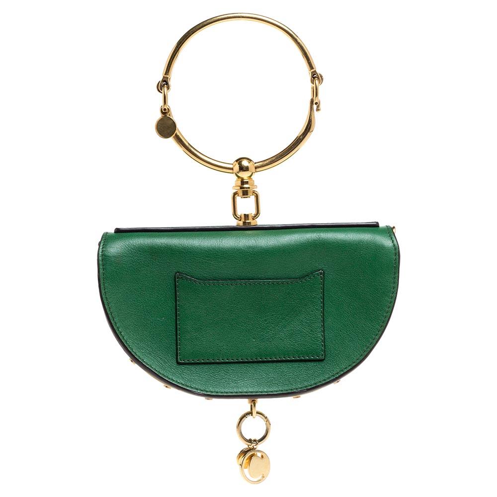 This Nile bag by Chloe can become your most favorite bag, thanks to its unique shape and the bracelet handle. It has been crafted from green leather and styled with a front flap that opens to a leather interior housing an open compartment and a slip