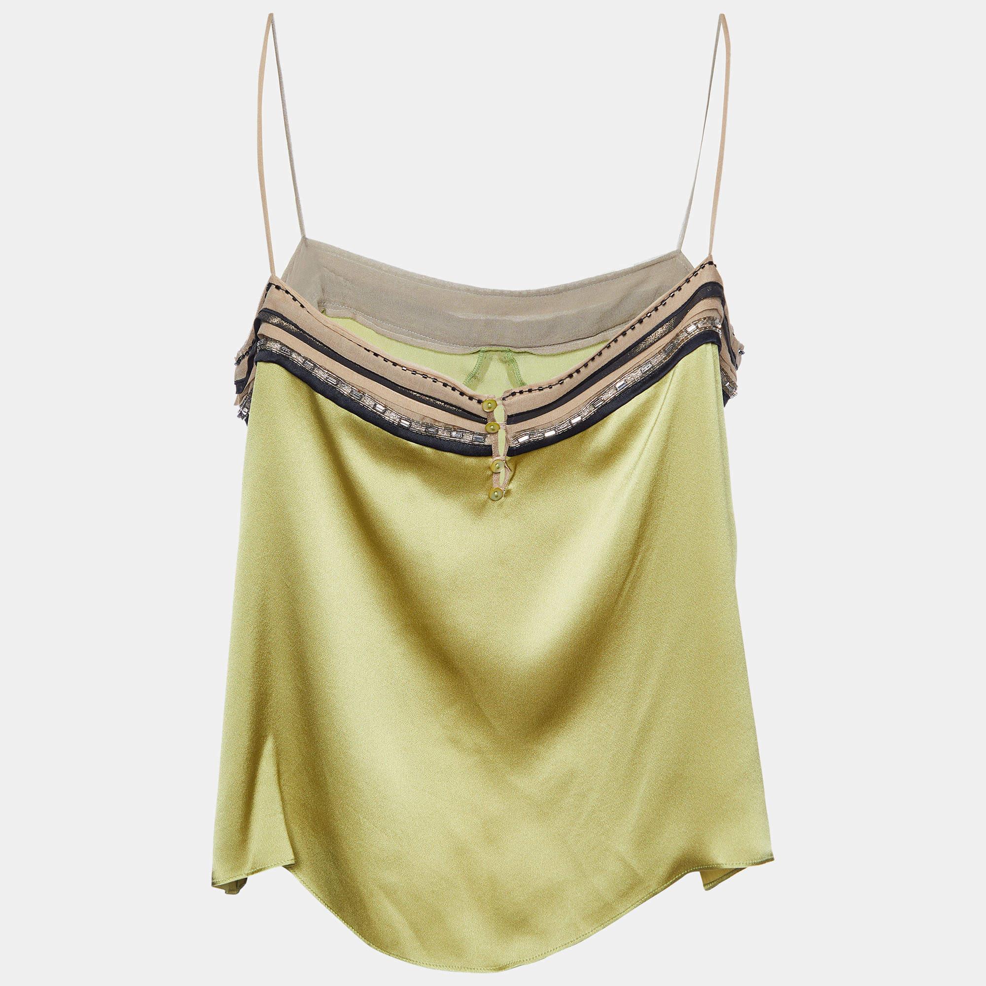 The Chloé cami top is a luxurious and elegant garment. Crafted from lustrous satin silk, it features delicate bead and sequin embellishments along the neckline, adding a touch of sophistication. The rich green hue exudes a sense of opulence and