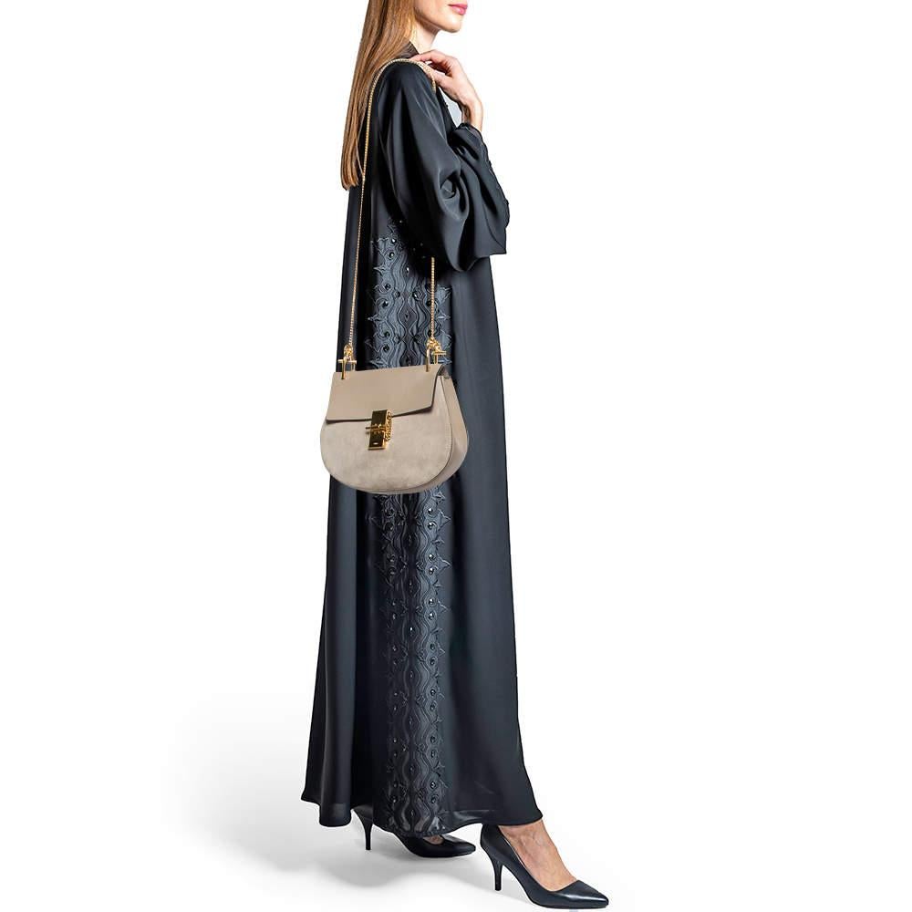 With its classic appeal and artistic design this Chloe bag will win your heart at the first sight. The gold tone accents and the attractive cut outs of this beige creation make it a standout piece in your closet. Created from leather and suede it