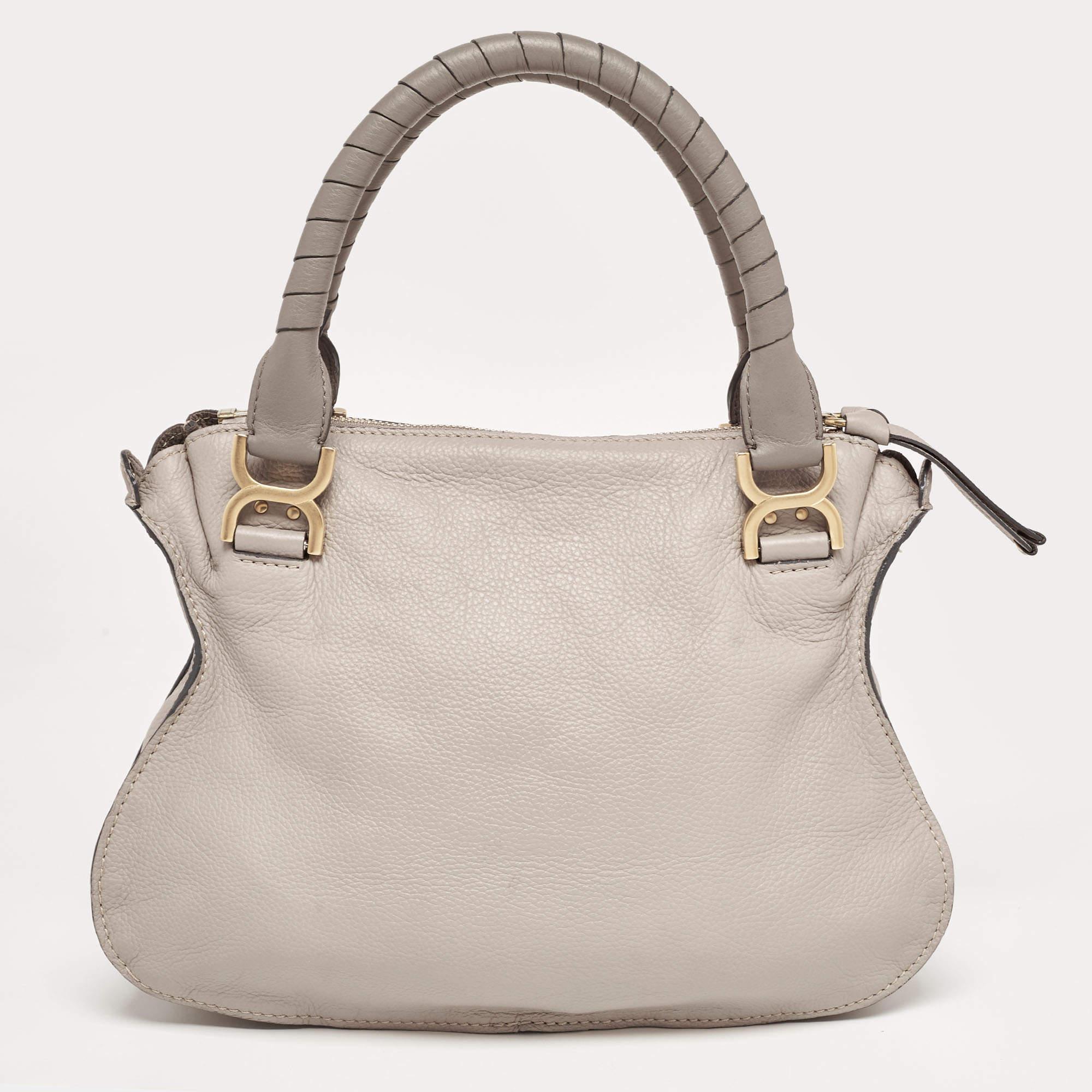 This Marcie Bag from the house of Chloé is a compact yet stylish bag with pretty braided details on it, making the bag even more pretty and feminine. This lovely creation crafted from leather features a top zipper closure and comes fitted with two