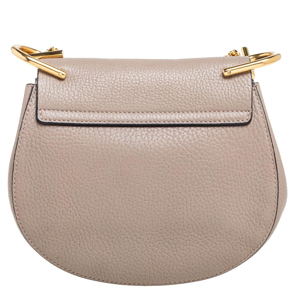 One of the most recognizable bags in the luxury world, Chloe's Drew bag carries a distinct shape and minimal style detailing. This small shoulder bag has been meticulously crafted from leather and designed with a pin lock closure and a shoulder