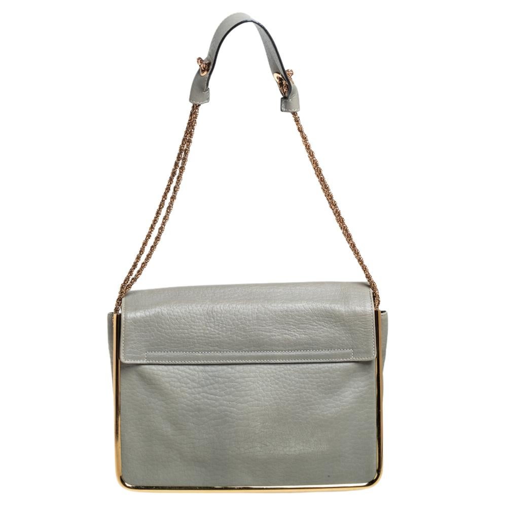 This Sally Flap shoulder bag by Chloe is a piece all fashionistas must look out for! Exquisitely crafted from pebbled leather, it features a chain shoulder strap with a leather band and a flap with a flip-lock closure that opens to a fabric-lined