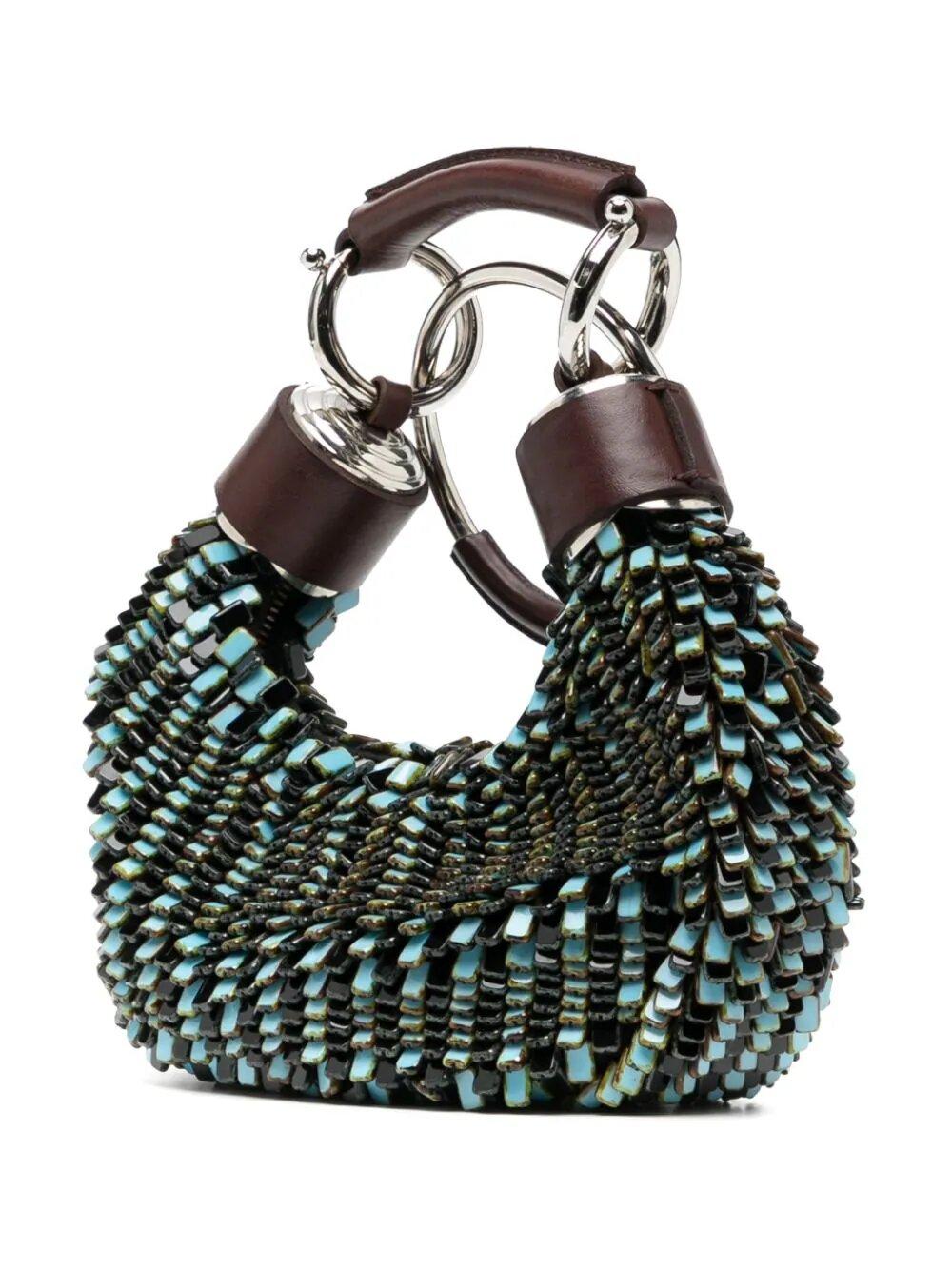 The Chloe Half Moon Bracelet Bag combines fashion and function with its unique glass beaded design. The composition, consisting of 20% Plexiglass and 80% leather, ensures durability and style. Elevate any outfit with this elegant and practical
