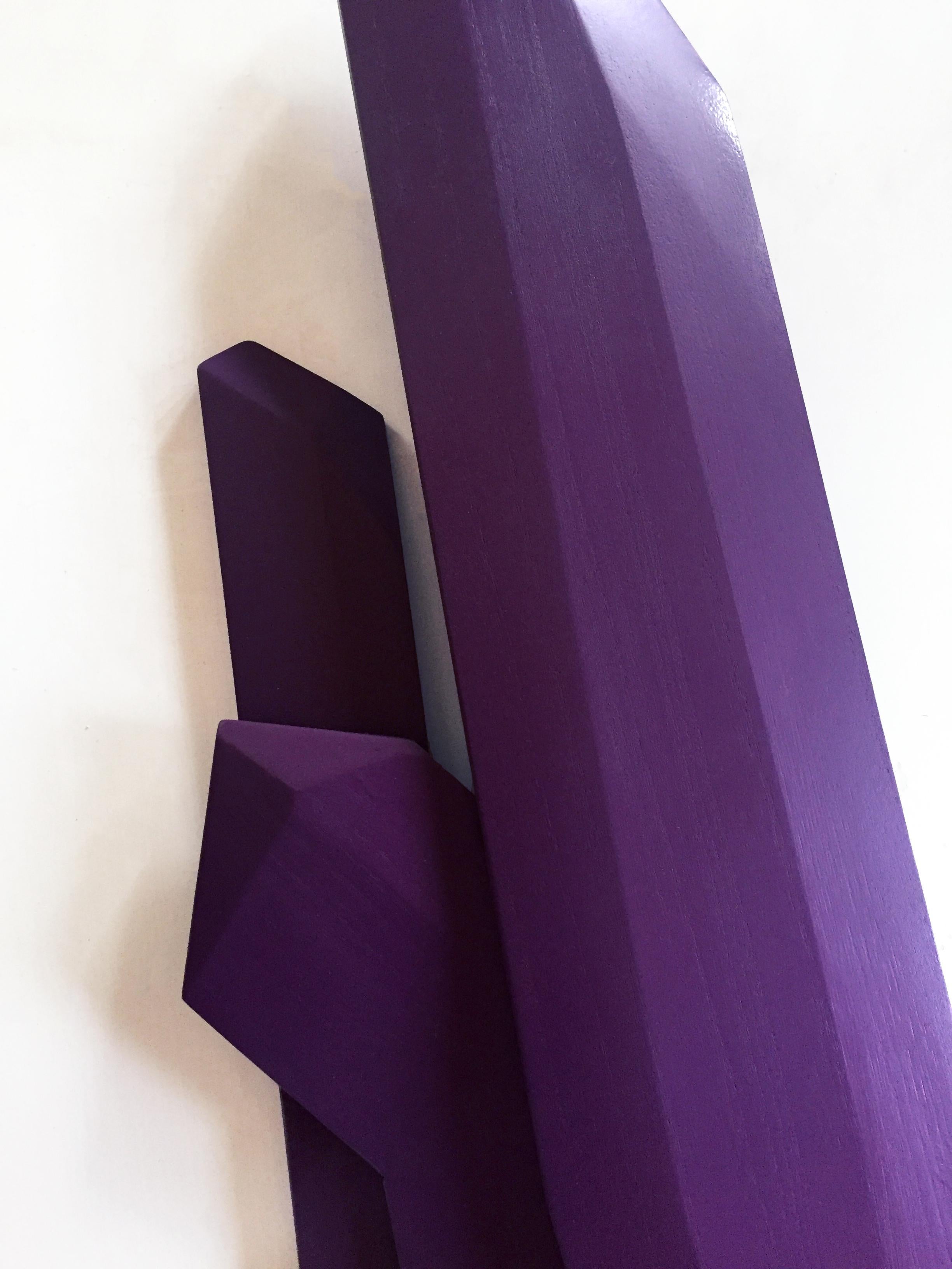 “Ultra Violet Crystals” is a rich plum colored wall sculpture made out of solid wood and then painted and sealed with a UV matte sealer. The geometric facets are hand carved and add intricacy to the structure. This creates a dynamic artwork where