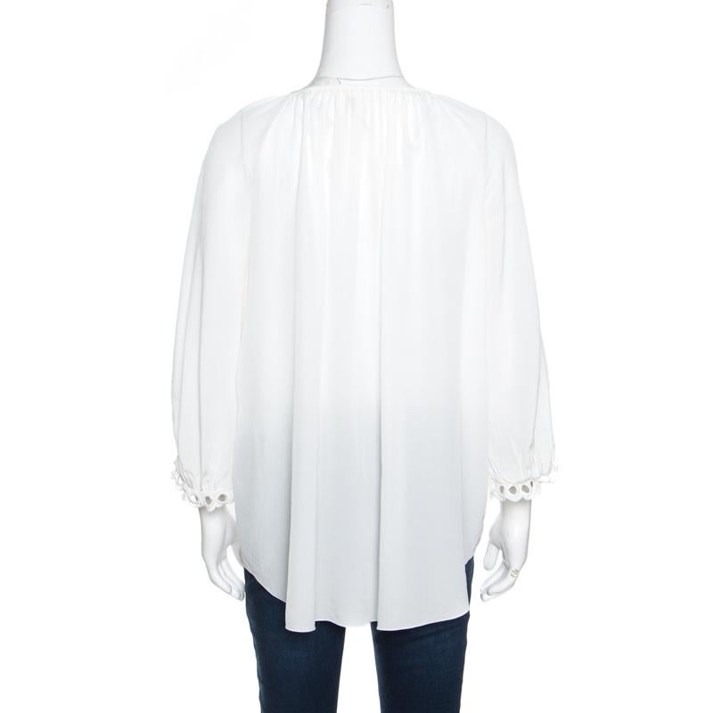 You are bound to make a statement in this lovely Peasant blouse from Chloe. The iconic milk white blouse is made of 100% silk and features a round pleated neckline with a self-tie fastening, a front button scalloped placket, wide three-quarter