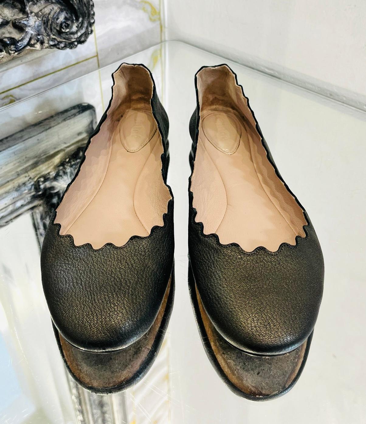 Chloe Leather Ballerina Flats

Black 'Lauren' ballerinas designed with scalloped trim.

Featuring almond toe, short heel and leather insoles and soles. Rrp £420

Size – 37

Condition – Good/Very Good (Small, general signs of wear, minor scratches to