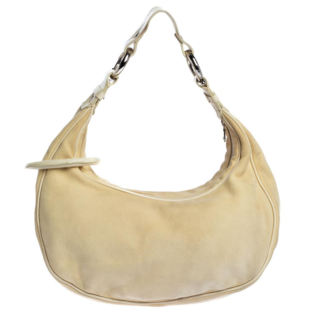 While you are waiting for the big party to come it is very definite to accessorize with this hobo from Chloe. It is made from canvas & leather and is studded with crystal embellishment forming the flower-shaped silhouette. The interior of this
