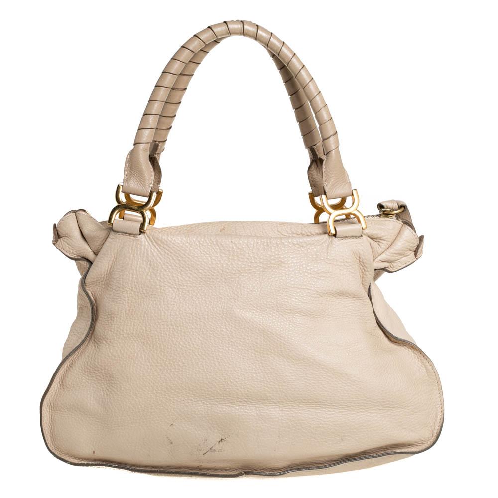 Stunning to look at and durable enough to accompany you wherever you go, this Chloe satchel is a joy to own! This Marcie bag is crafted from leather with dual handles and a well-designed front exterior enhanced with stitch detailings and gold-tone