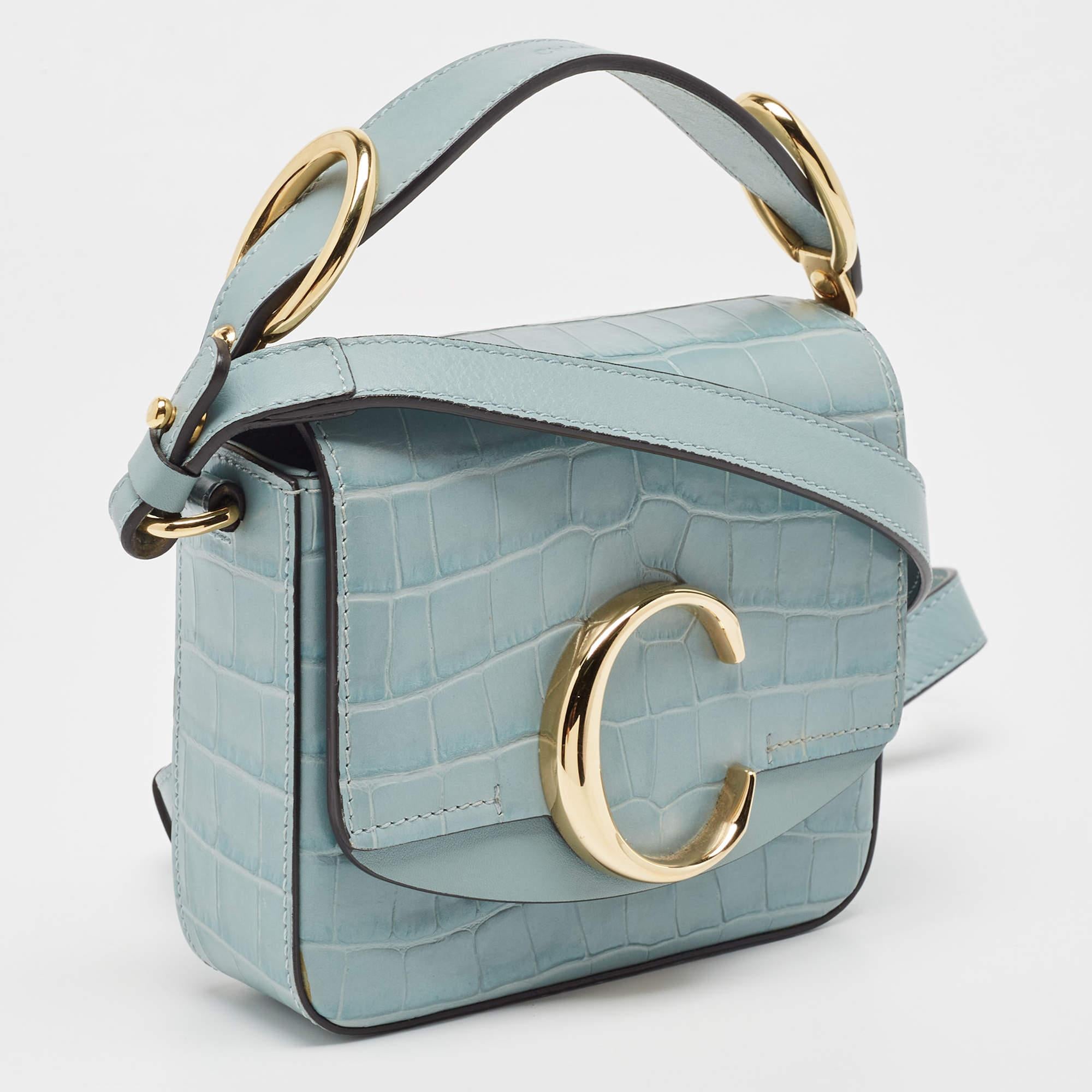 This Chloé's bag is a part of the much-loved C collection and has a structured silhouette that's particularly sleek and classy. Made from croc-embossed leather, it's the light blue shade that beautifully complements the gold-tone hardware. It