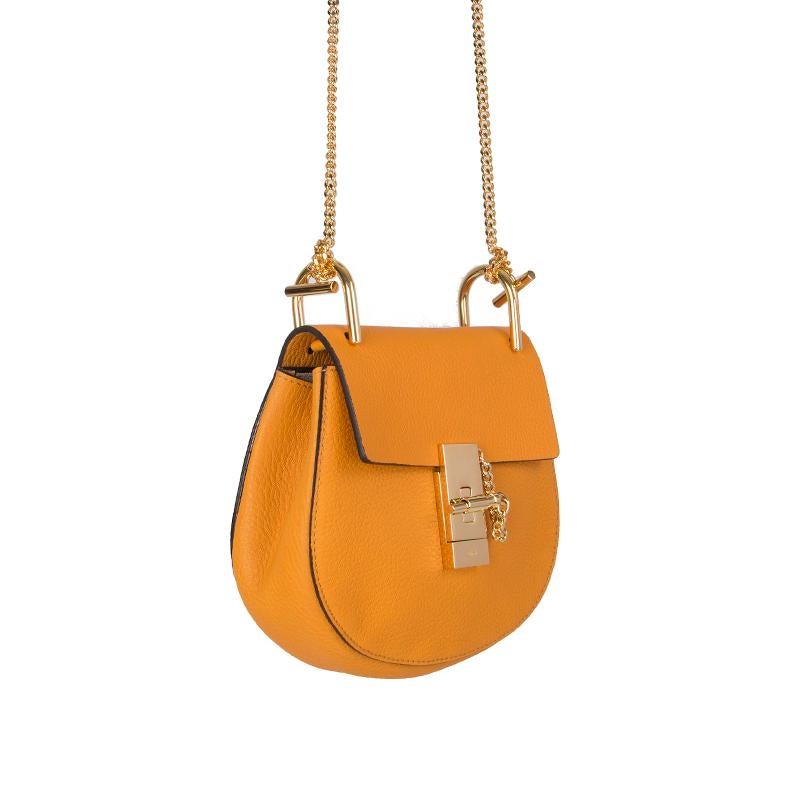Chloe 'Drew Mini' shoulder bag in mango grained lambskin leather. Closes with a gold-tone turn-lock on the front. Lined in beige suede with an open pocket against the back. Has been carried once or twice and is in virtually new condition. Comes with