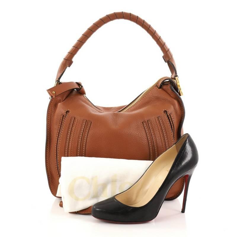This authentic Chloe Marcie Hobo Leather Medium showcases the brand's popular horseshoe design in a classic hobo design. Constructed from beautiful brown leather, this functional yet stylish hobo bag features a slouchy, easy-to-carry silhouette,