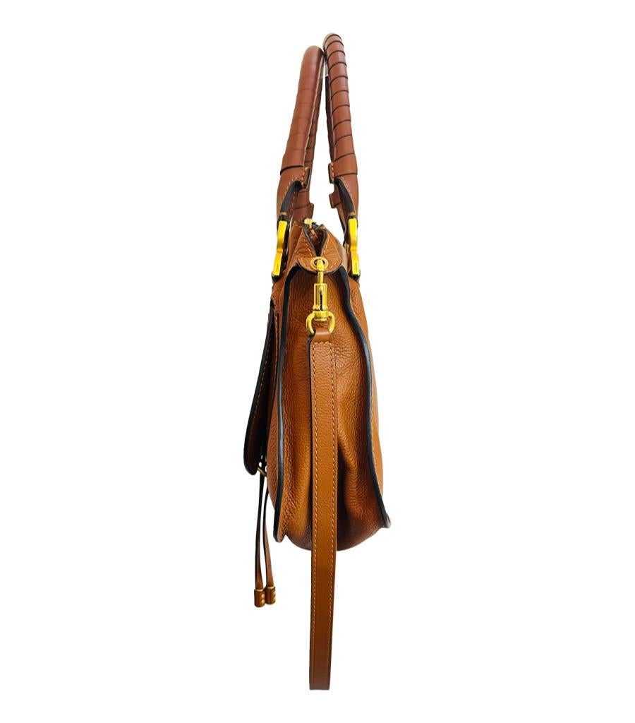 Chloe Marcie Leather Bag

Tan brown carry bag crafted from grained calfskin with hand-wrapped leather handles and crafty details.

Featuring slouchy silhouette and gold hardware with 'Chloe' engravements and logo embossment to the front.

Styled