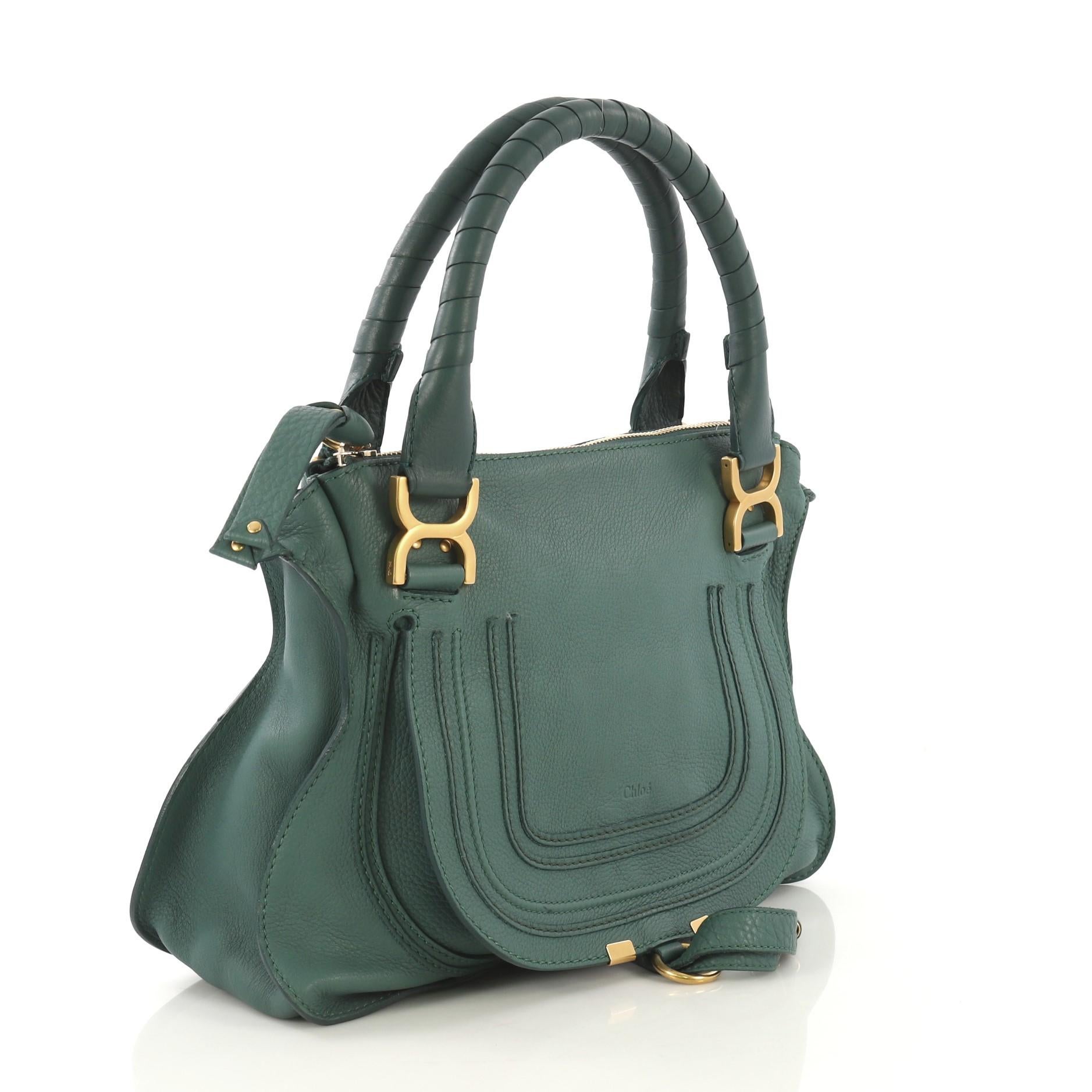 This Chloe Marcie Satchel Leather Medium, crafted in green leather, features wrapped leather handles, horseshoe stitched front flap, and gold-tone hardware. Its top zip closure opens to a green fabric interior with zip and slip pockets. 

Estimated