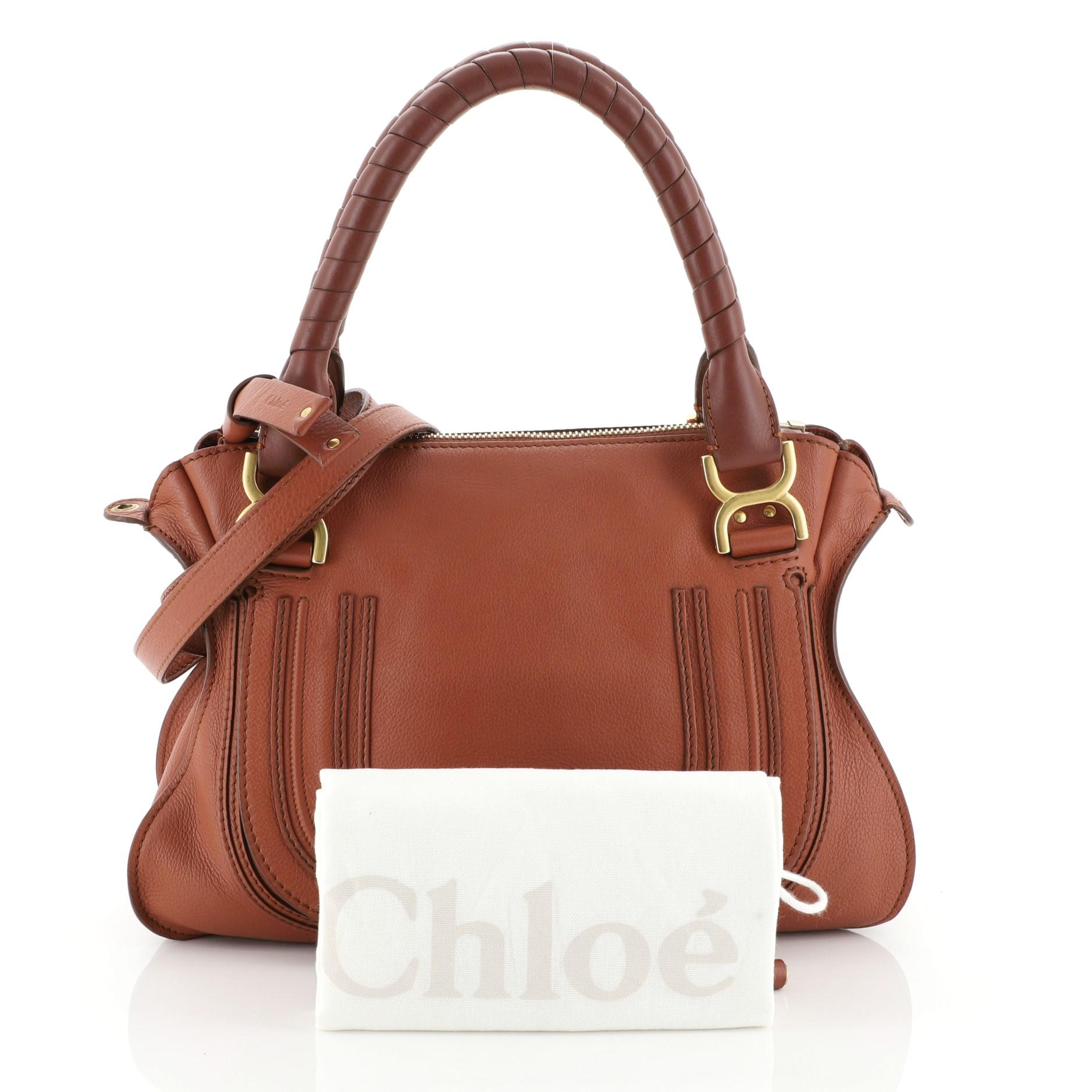 This Chloe Marcie Satchel Leather Medium, crafted in orange leather, features wrapped leather handles, horseshoe stitched front flap, and gold-tone hardware. Its top zip closure opens to a green fabric interior with zip and slip pockets. 

Estimated