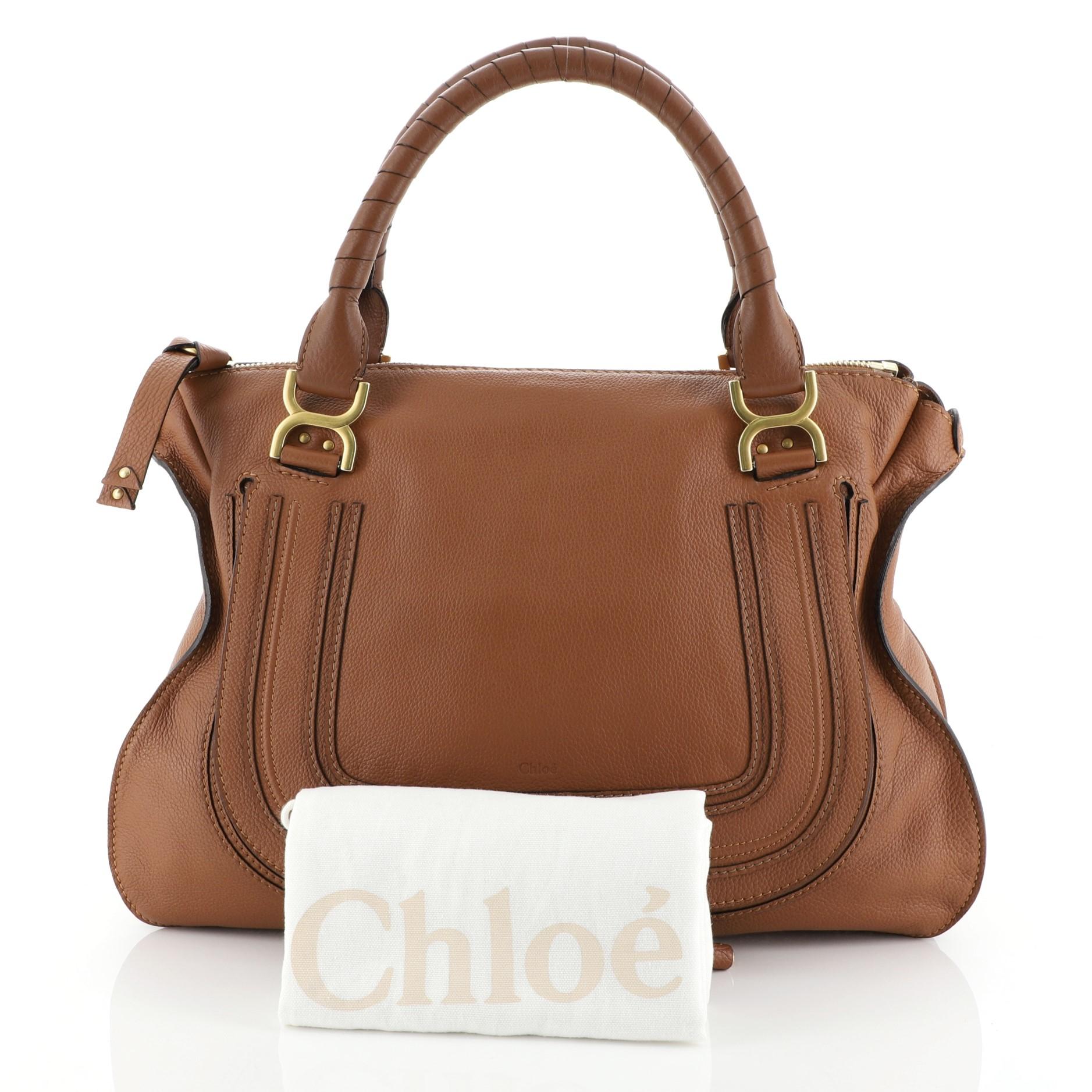 This Chloe Marcie Shoulder Bag Leather Large, crafted from brown leather, features wrapped leather handles, horseshoe stitched front flap, and gold-tone hardware. Its zip closure opens to a green fabric interior with zip and slip pockets.