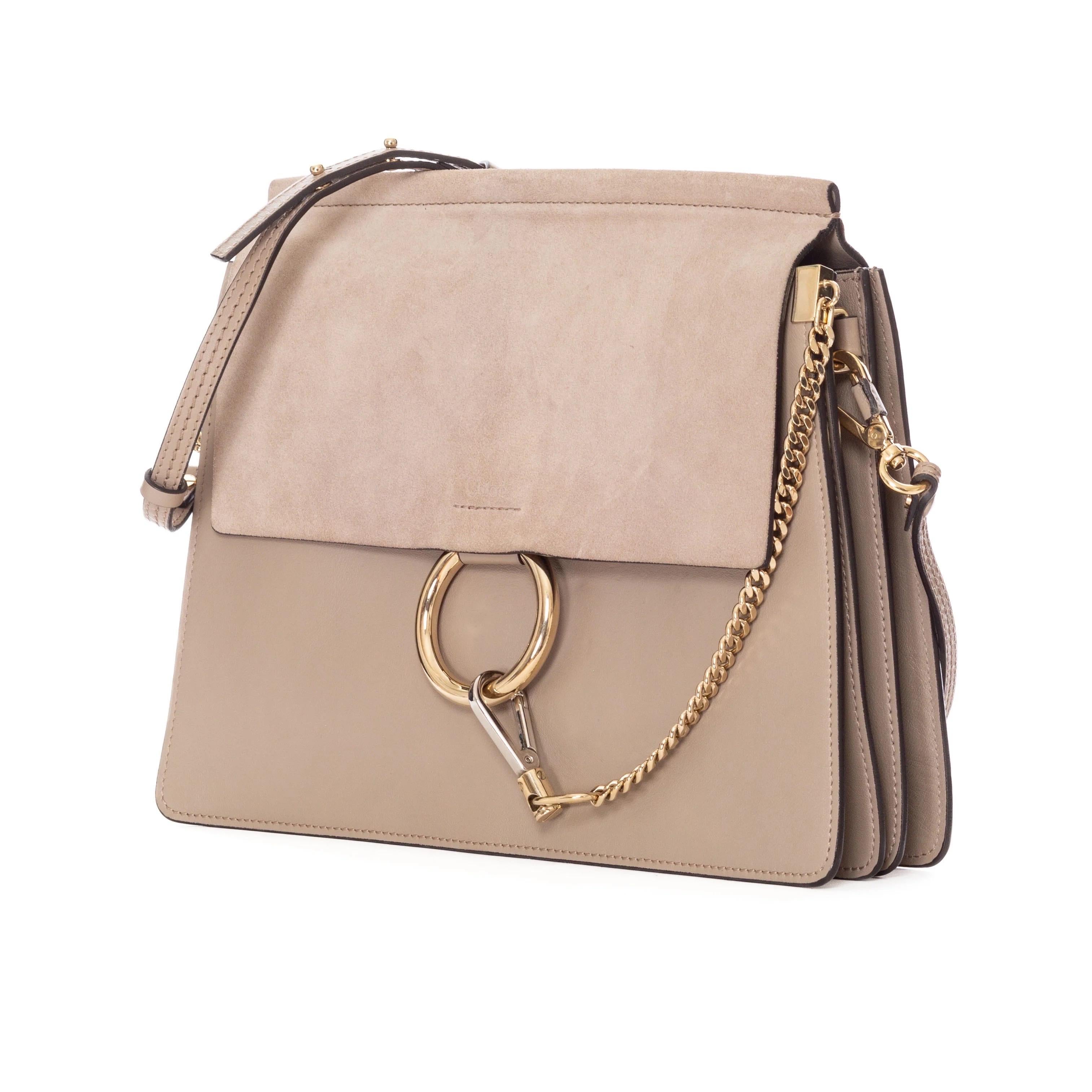 Chloé Medium Faye Motty Grey Suede and Leather Shoulder Bag

2016
Motty Grey / Taupe
Front flap with snap closure
Adjustable removable shoulder strap
Two-tone hardware
Signature matte gold ring with silvery chain (hooks to ring)
Accordion shape