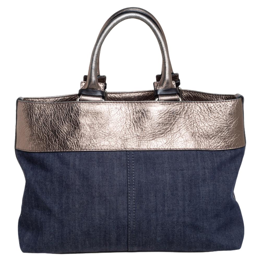 Grab this fun and casual bag by Chloe today! The denim and leather mix, zipper details at front, two leather handles, and gunmetal-tone hardware, all are details that make it a trendy yet relaxed bag. The interior is lined with canvas with one